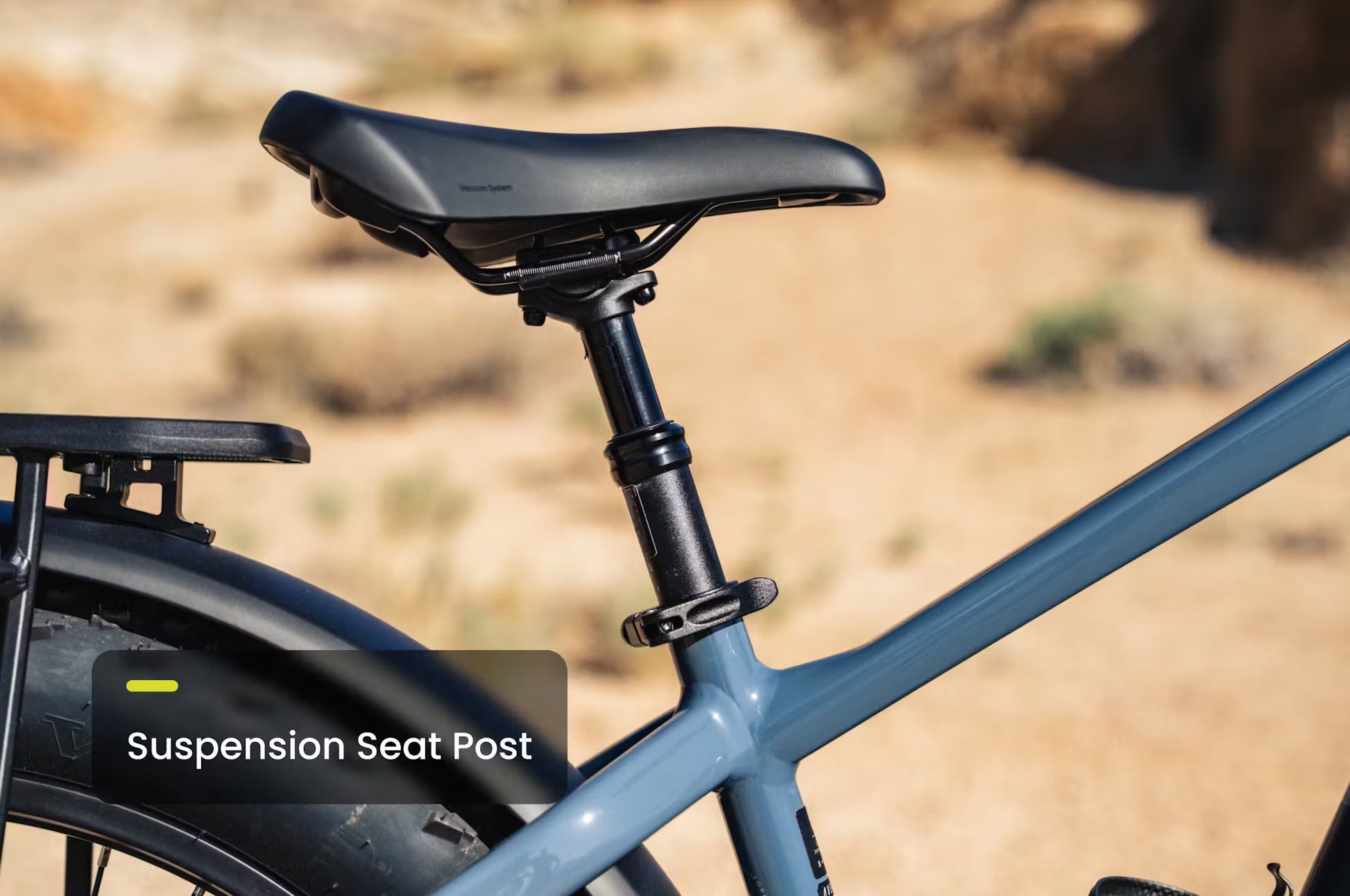 Rex E-Bikes Aventon Aventure.M E-Bike in black with thick tires and electric motor, parked on a city street.