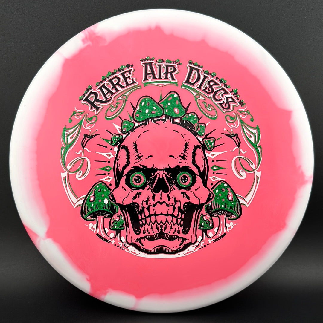 Halo S-Blend Tomb disc golf stamp by Manny Trujillo on a Rare Air Discs disc featuring Crushin' Amanitas artwork and vibrant colors.