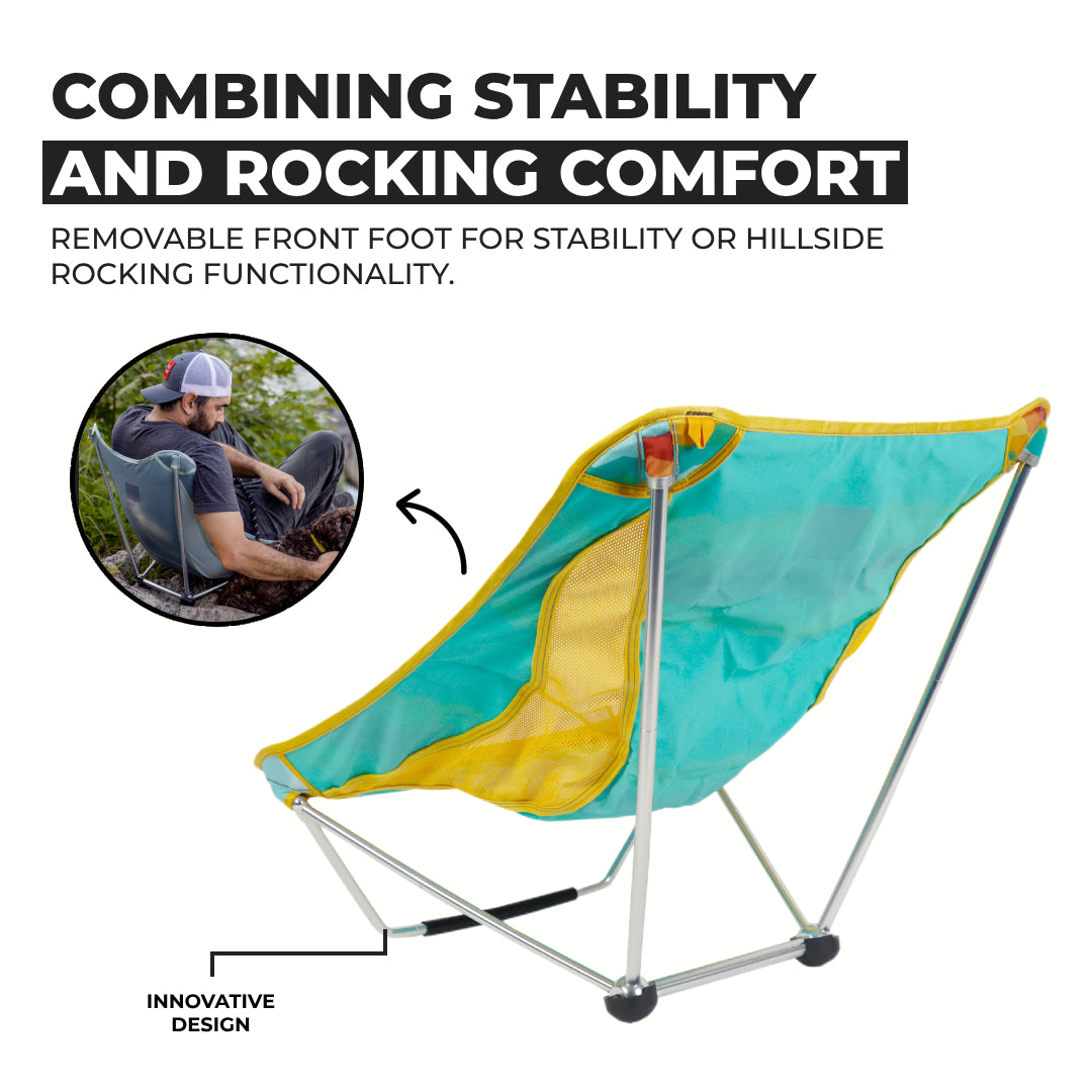 GrandTrunk Mayfly Low Ground Collapsible Chair set up outdoors, lightweight portable camping seat with fabric seat and metal frame.