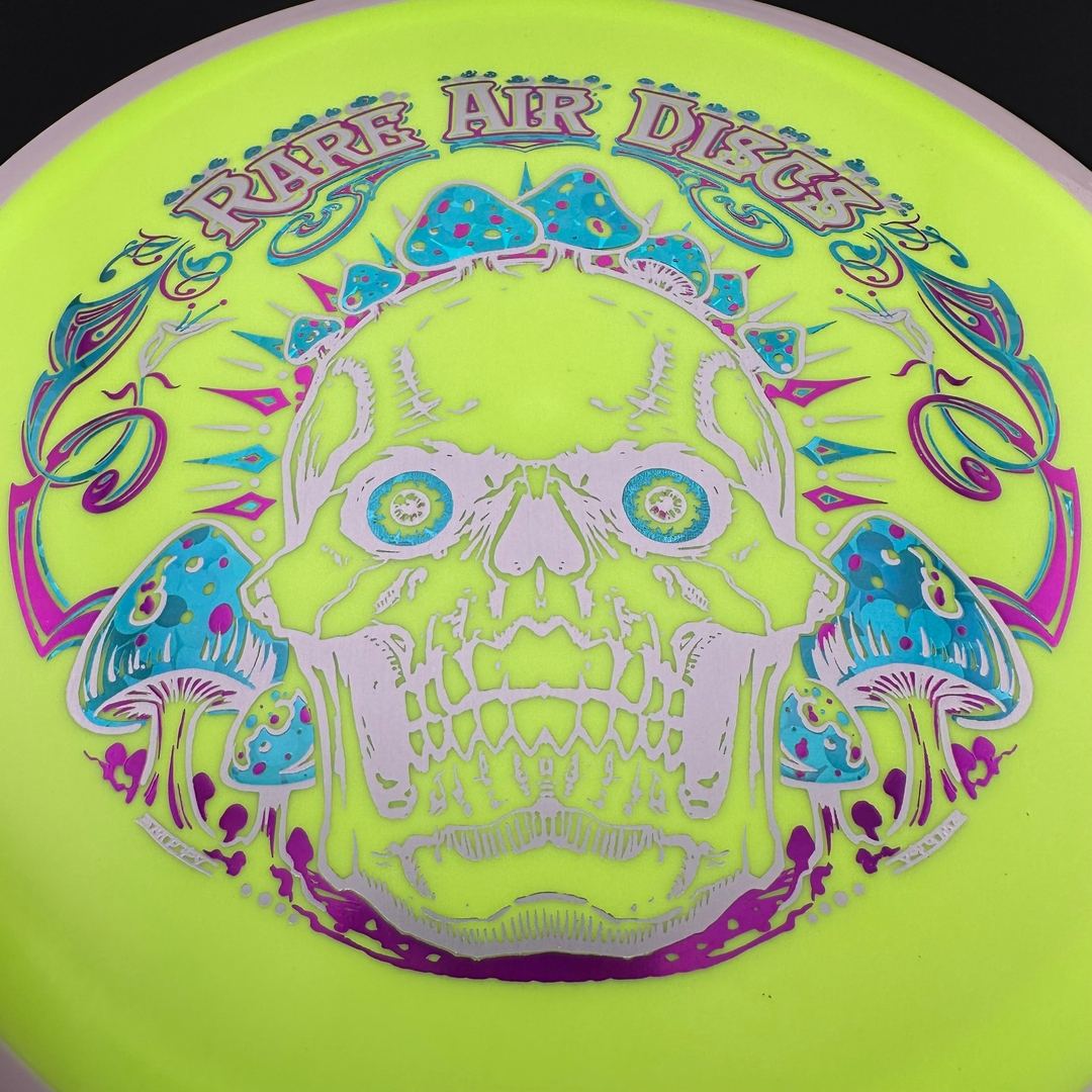 Fission Defy Crushin' Amanitas VIP 2.0 disc golf disc by Rare Air Discs, showing bright colors and detailed design on the disc surface.