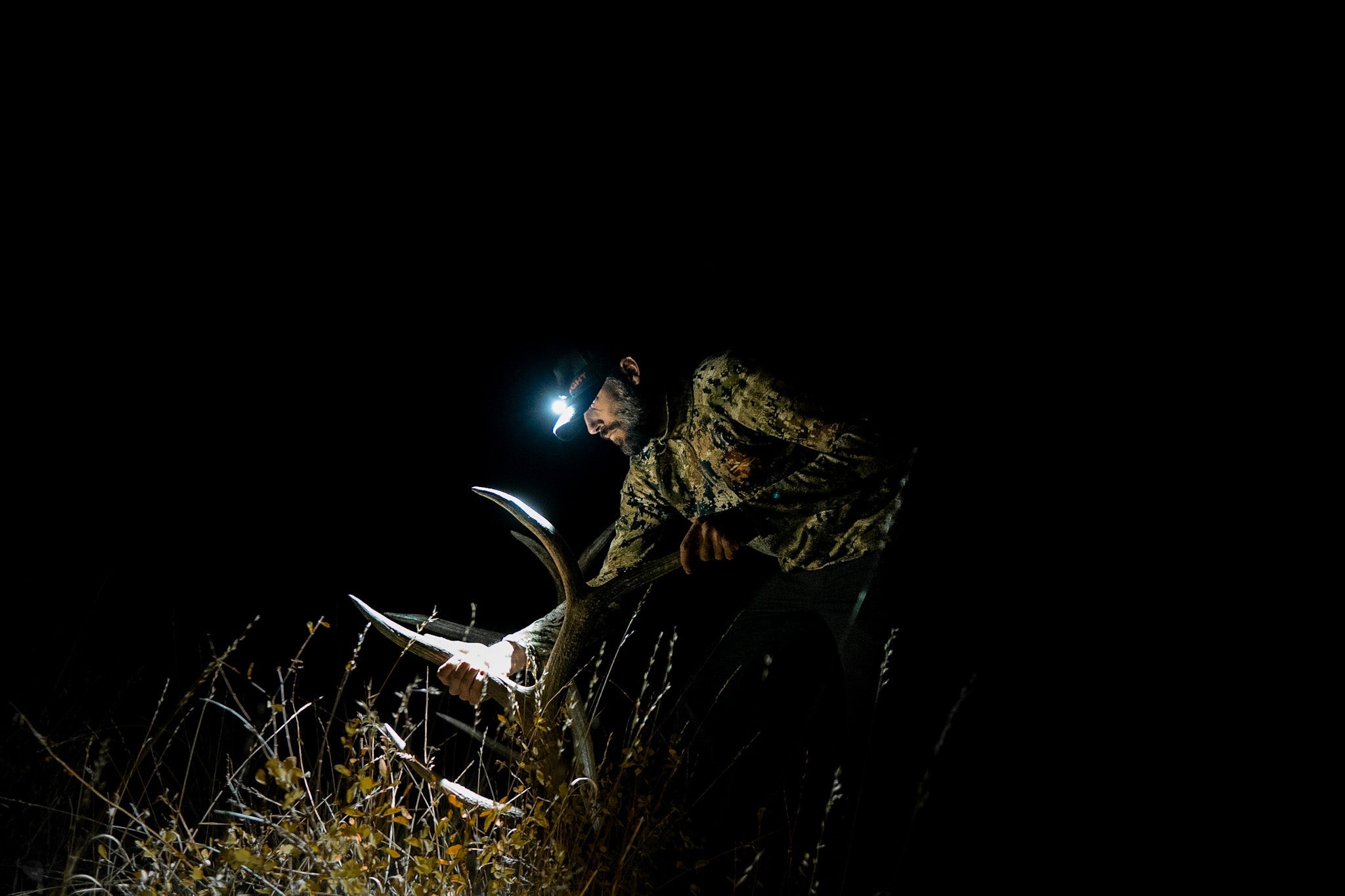 Last Light LLC Strike 1800 headlamp showing adjustable straps and bright LED light for hands-free illumination.