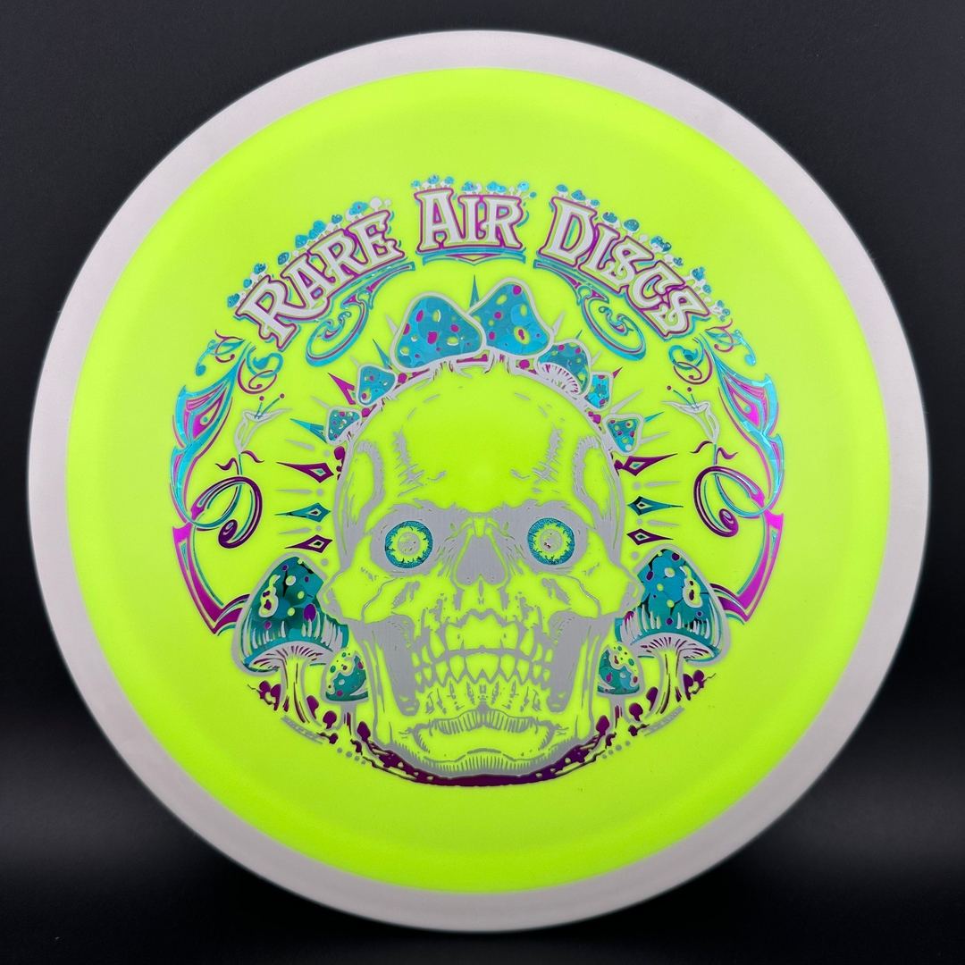 Fission Defy Crushin' Amanitas VIP 2.0 disc golf disc by Rare Air Discs, featuring vibrant colors and detailed branding.