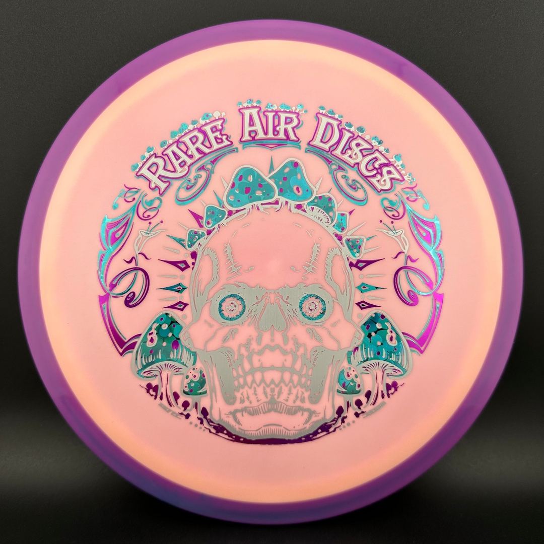 Rare Air Discs Fission Defy Crushin' Amanitas VIP 2.0 disc golf disc with colorful design and bold lettering on the flight surface.