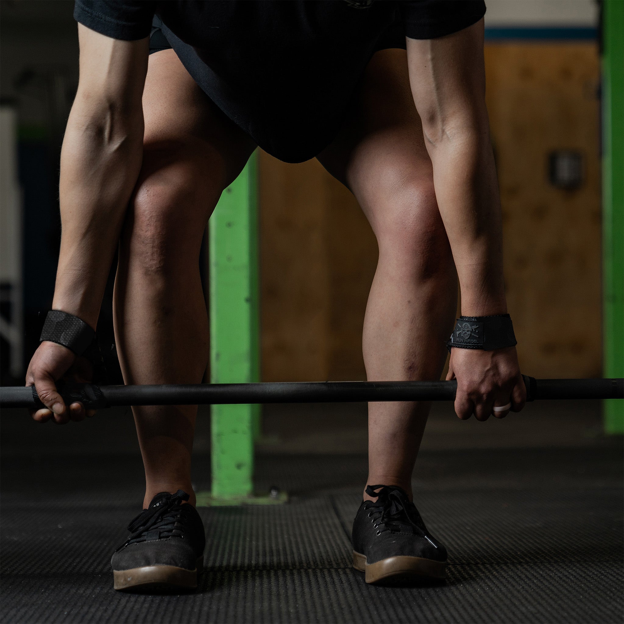 Iron Infidel lifting straps for enhanced grip during weightlifting, featuring durable fabric and reinforced stitching.
