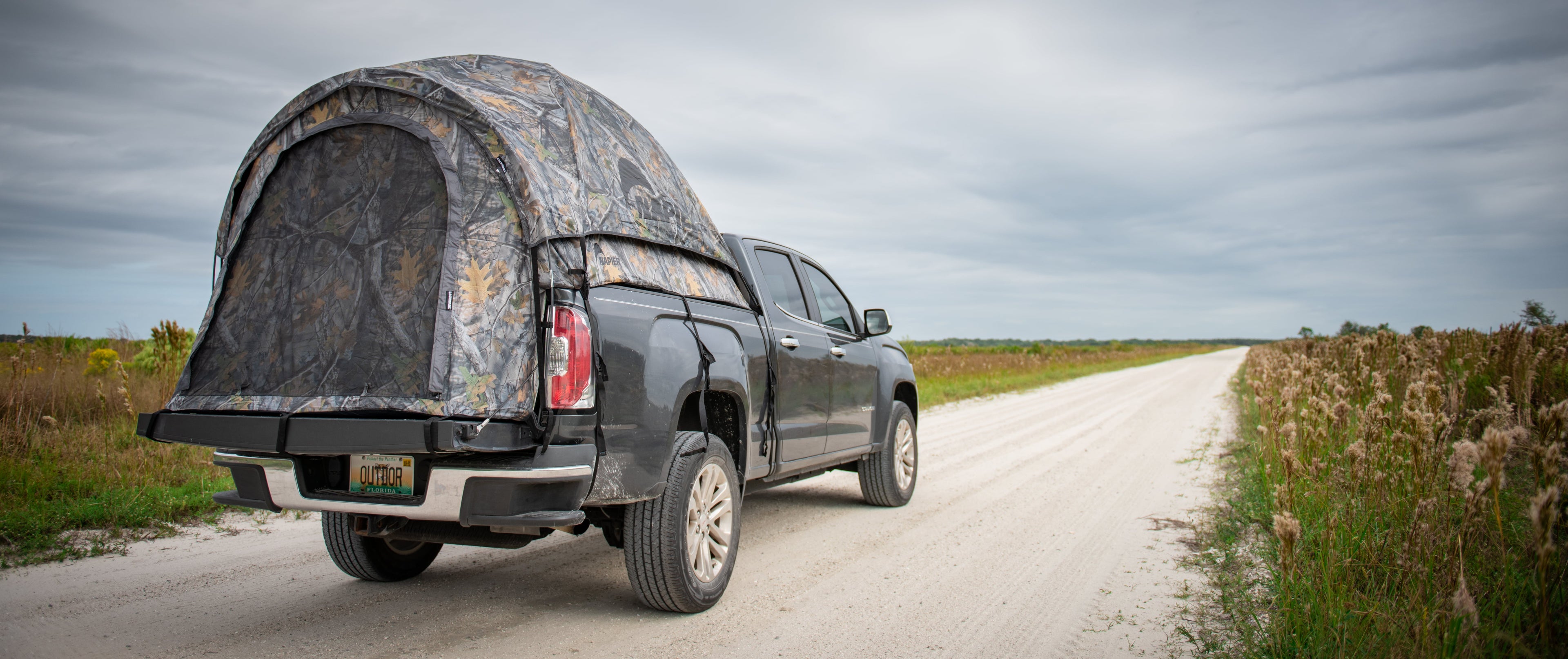 Backcountry Sportsman truck tent set up on a pickup truck bed, showcasing its durable fabric and spacious interior for camping.
