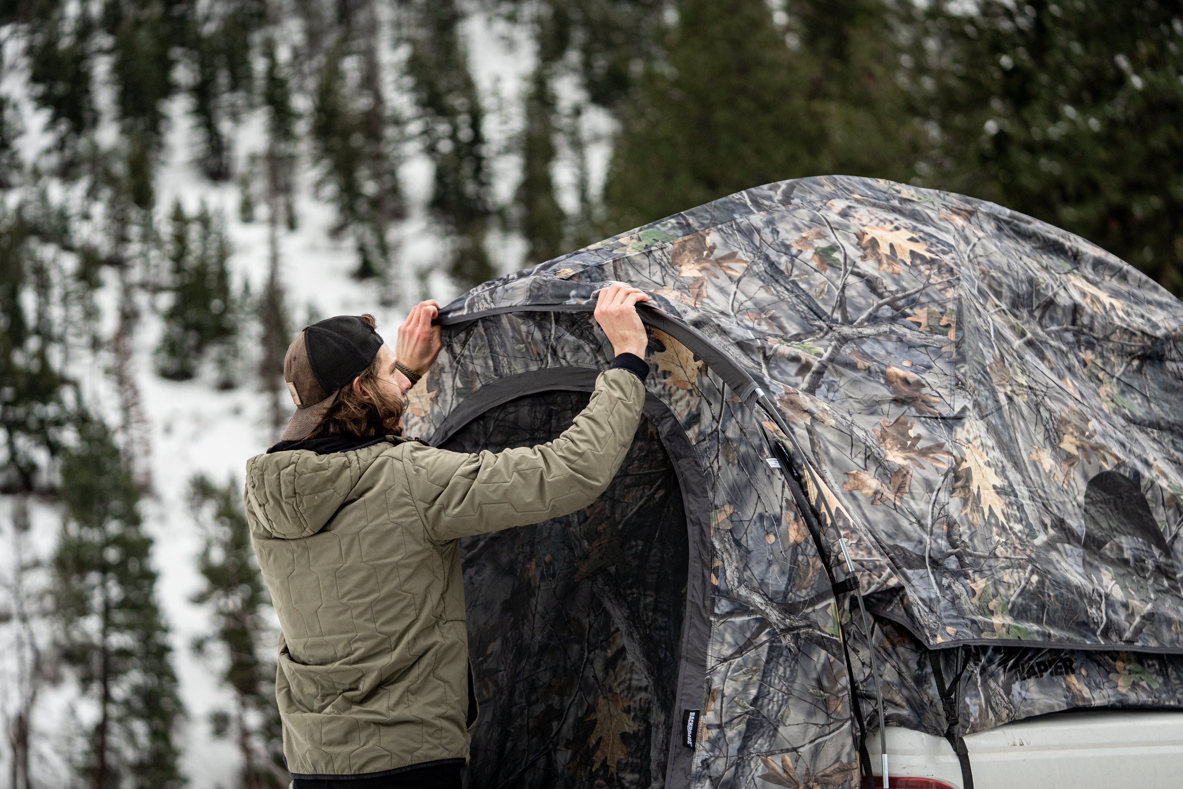 Backcountry Sportsman truck tent set up on a vehicle, showcasing durable fabric and spacious interior for outdoor camping adventures.