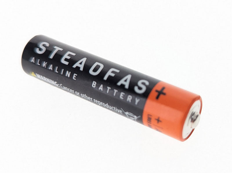 Three heavy-duty AAA batteries from Quakekits.com, showing the durable metal casing and positive terminal.