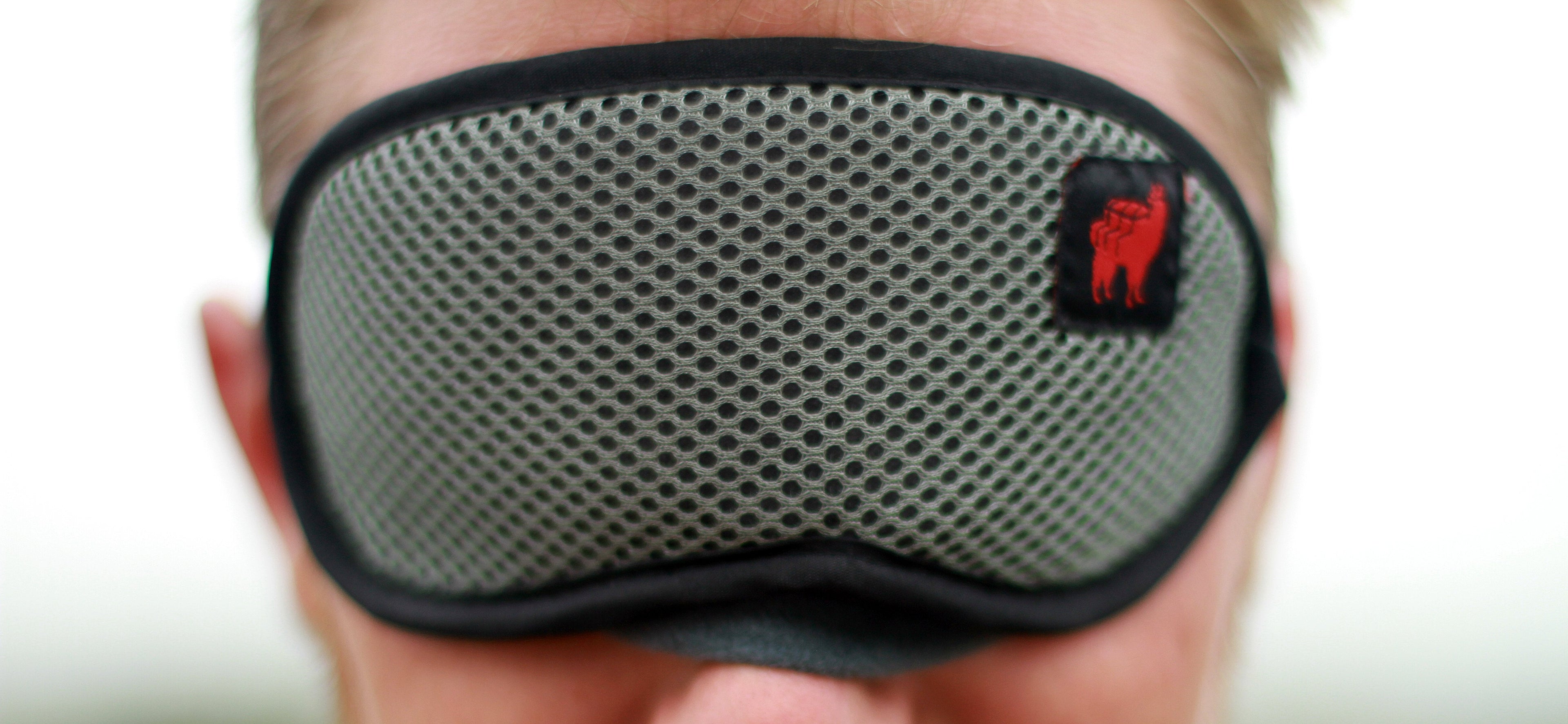 Blackout travel eye and sleep mask from GrandTrunk with adjustable strap, designed for comfortable sleep during travel.