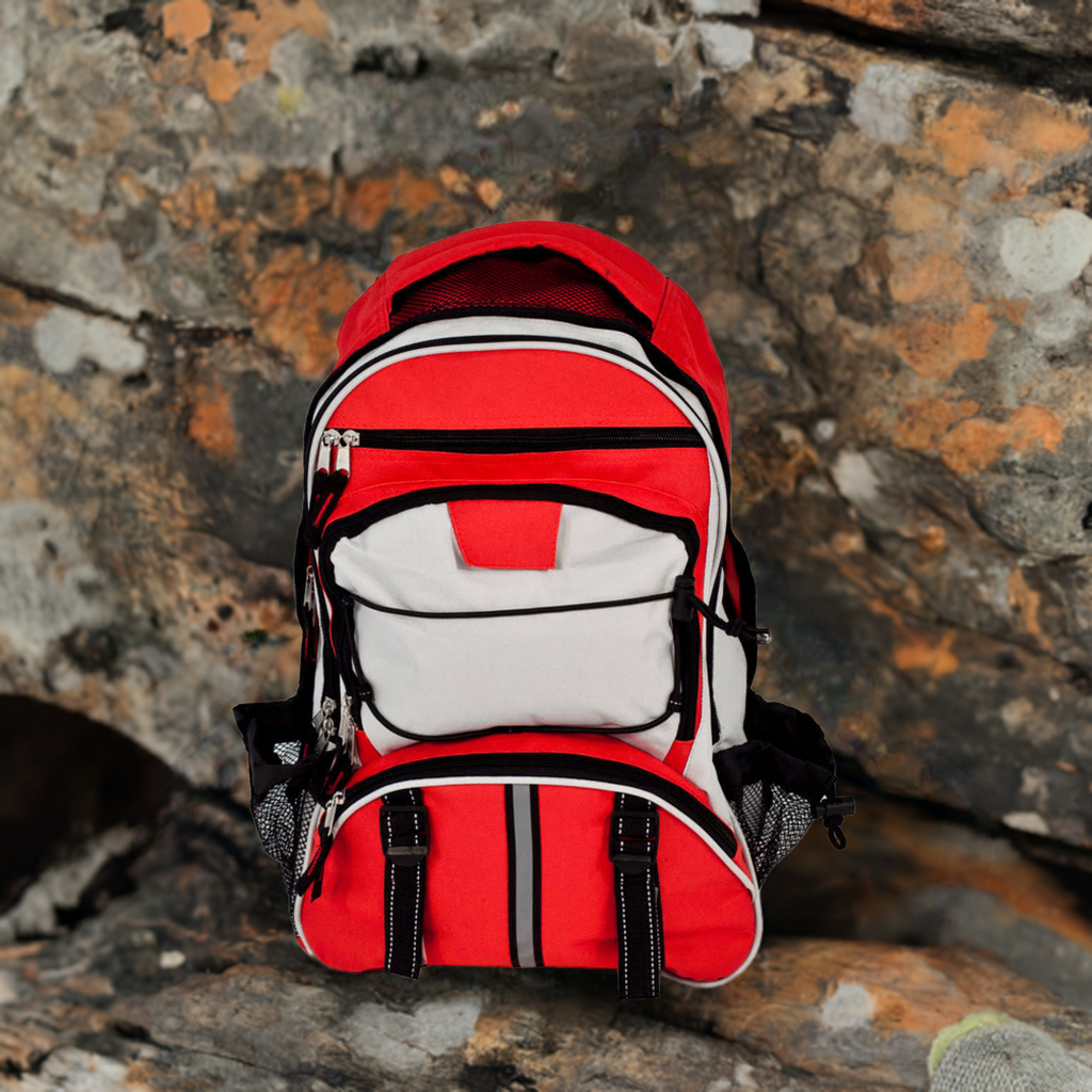 Red Elite Multi-pocket Hikers Backpack by QuakeKits with mountain and boulder background, showcasing durable outdoor gear.
