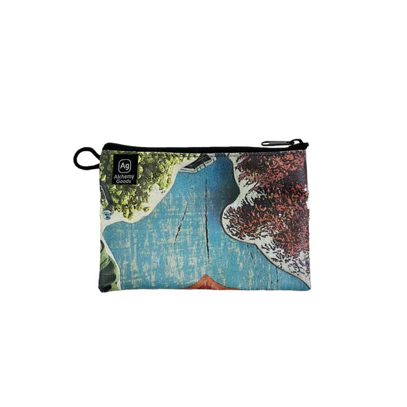 ZEITBIKE Alchemy Goods zipper pouch with liner, displayed on a banner, showcasing its upcycled material and compact bag design.