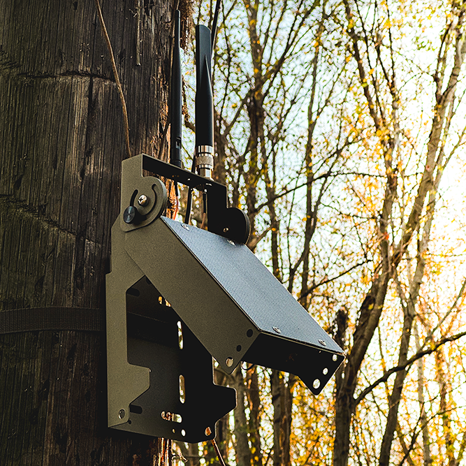 Atlaxox Beacon Solar Meshtastic Node mounted on a pole, showcasing its compact radio design and solar power feature.