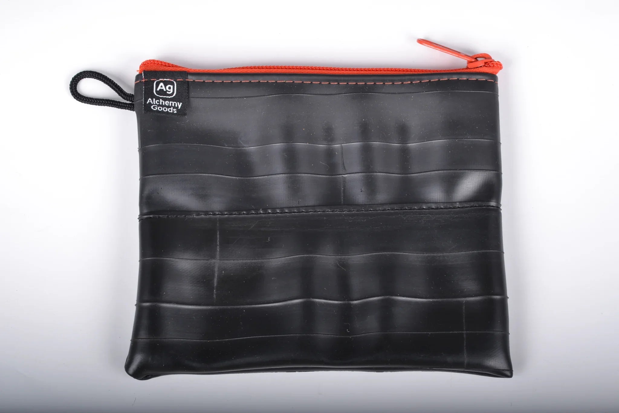 Large zipper pouch by ZEITBIKE from Alchemy Goods, made with recycled materials, featuring a durable liner and vibrant mandarin color.