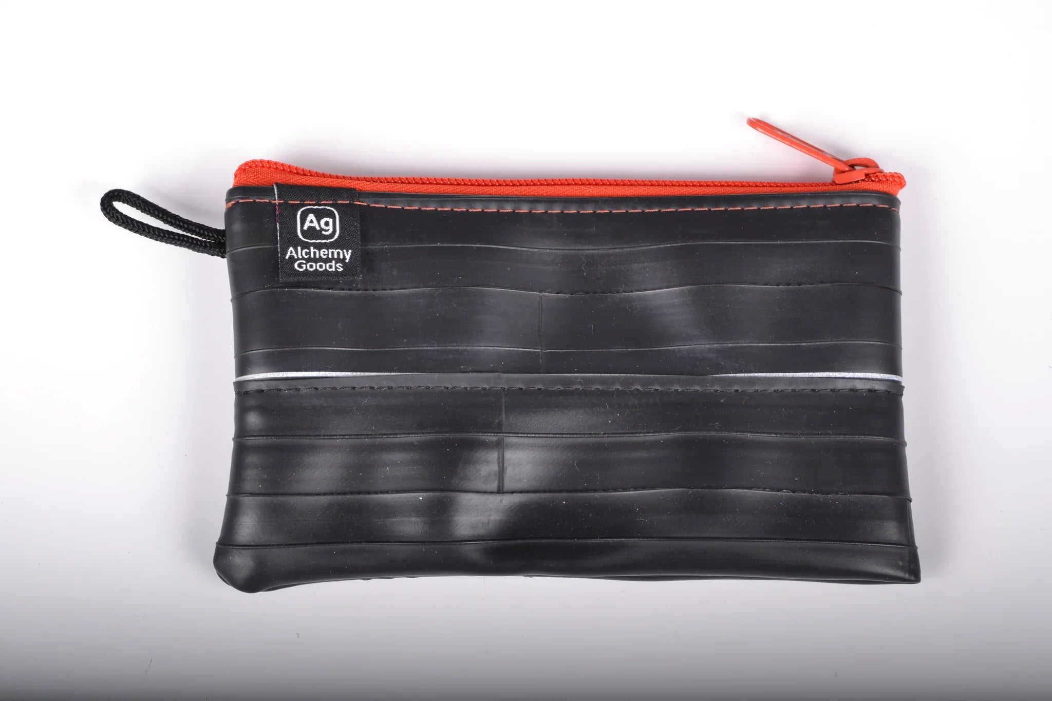 Recycled mid-size zipper pouch by ZEITBIKE from Alchemy Goods, featuring a vibrant mandarin color and durable liner.