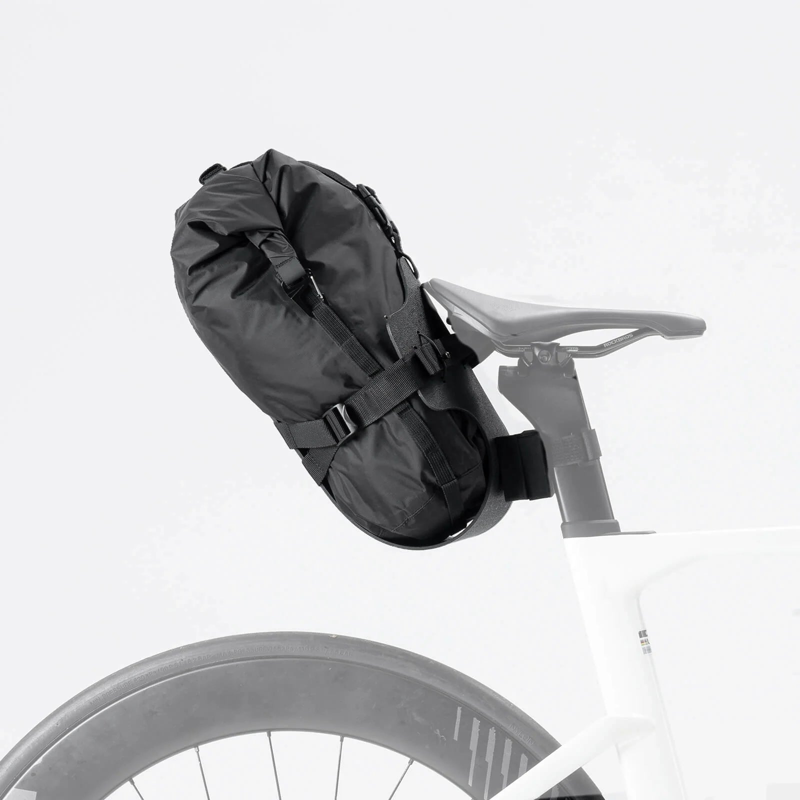Qunature Global bikepacking rear rack with waterproof compression bag, mounted on a bicycle for outdoor adventures.