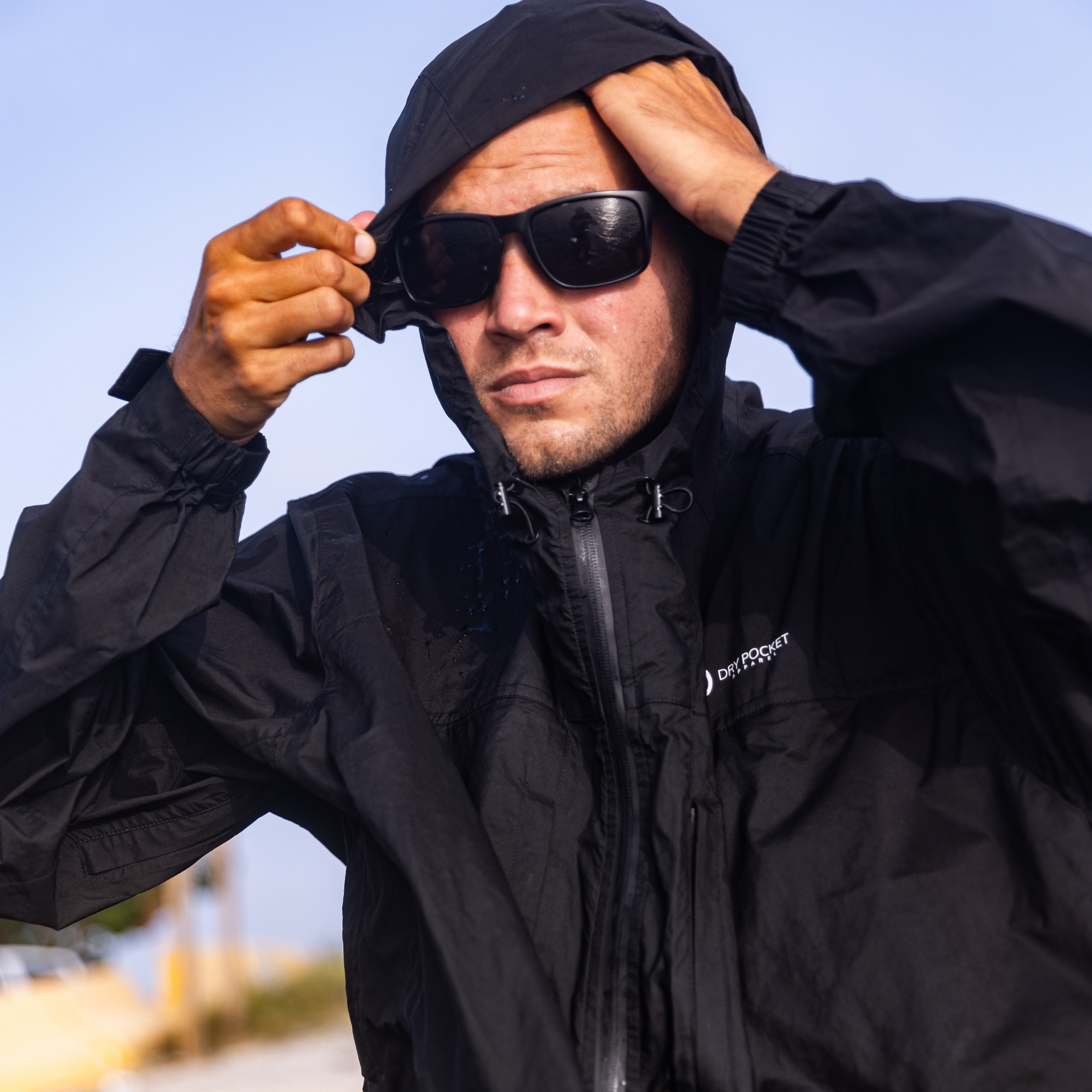 Black Fin waterproof rain jacket with a waterproof pocket, ideal for fishing and outdoor rain protection by Dry Pocket.
