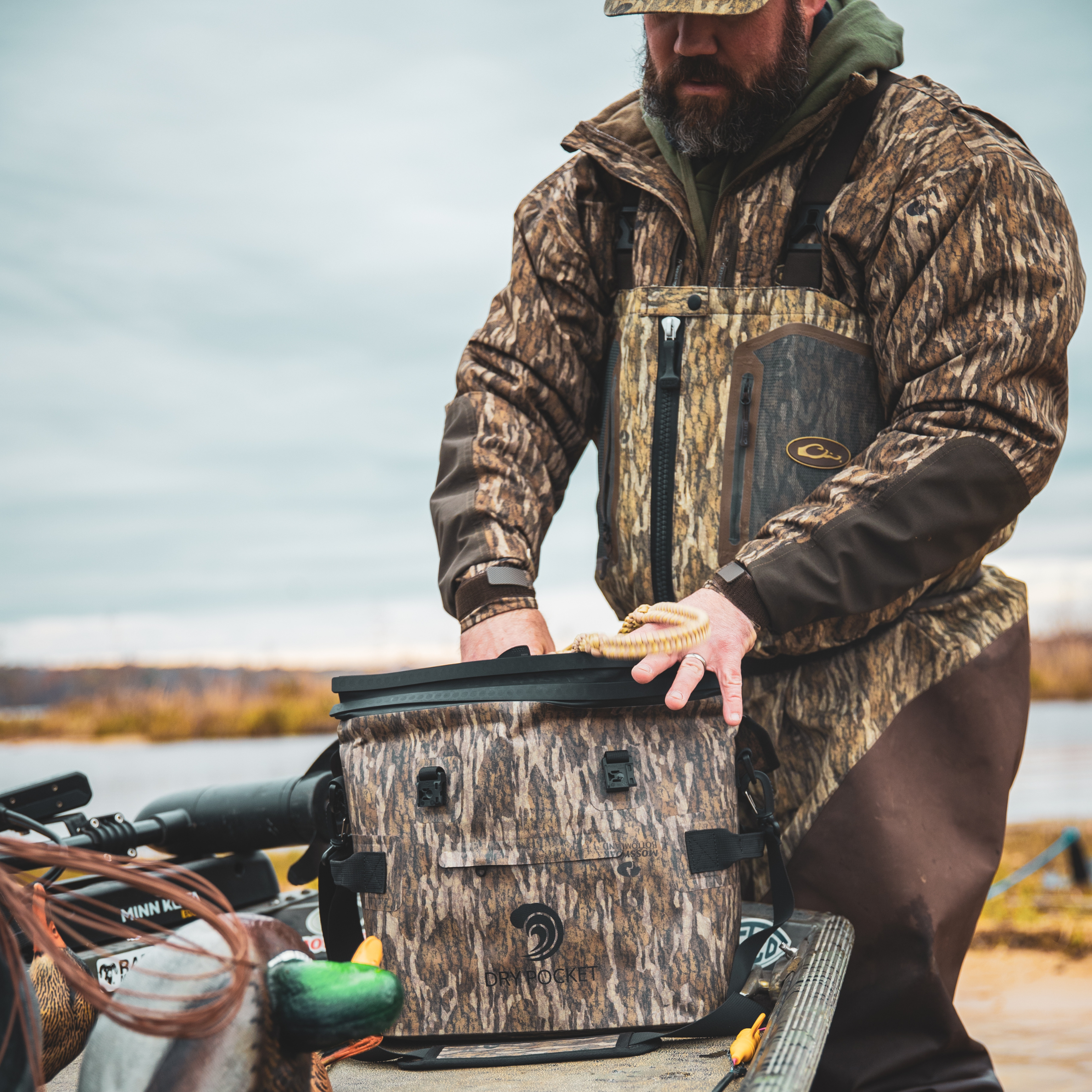 Dry Pocket waterproof floating cooler bag, auto sealing tote cooler with bottomland camouflage design and sturdy construction.