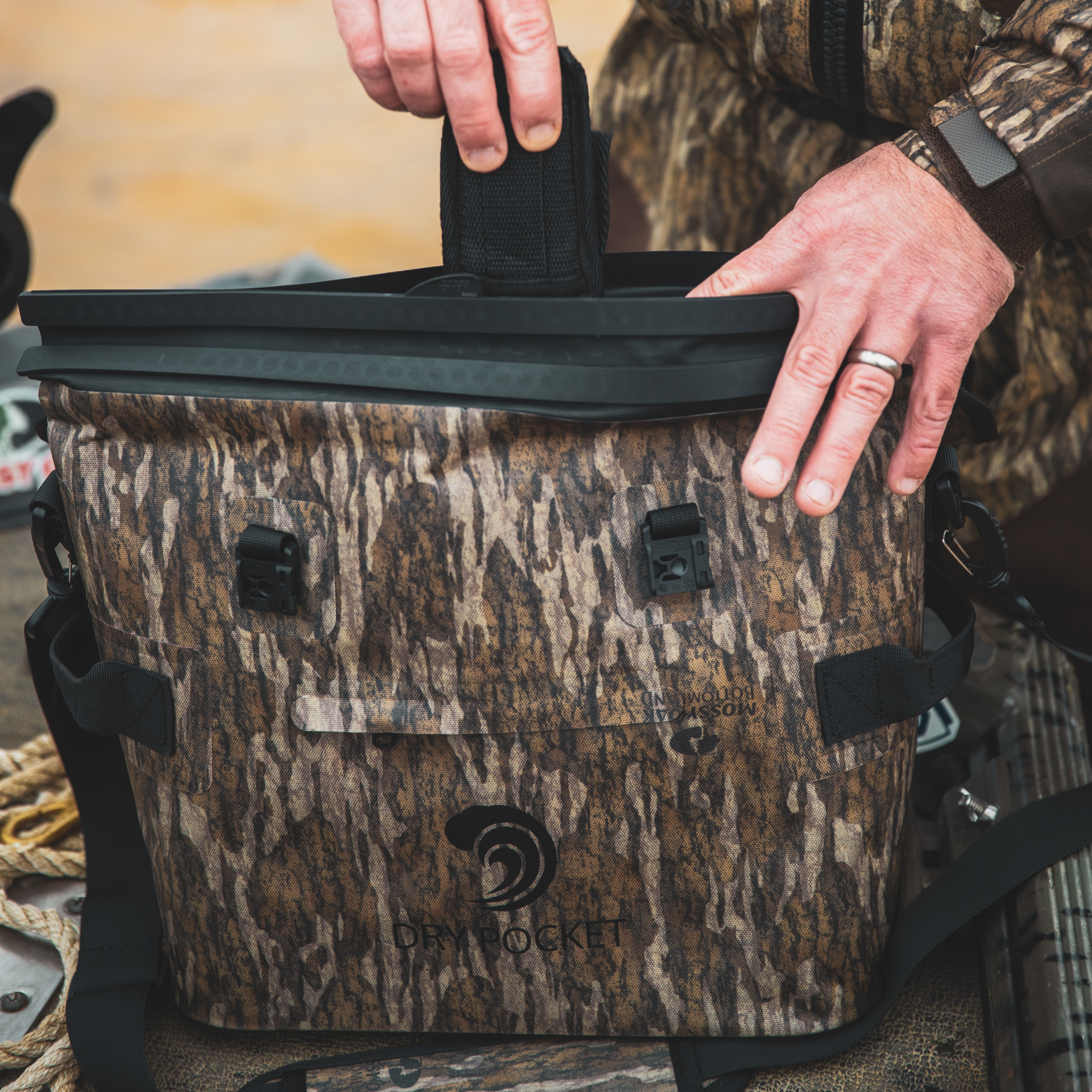 Dry Pocket waterproof floating cooler bag with auto sealing tote design, shown from the bottomland day pack perspective.