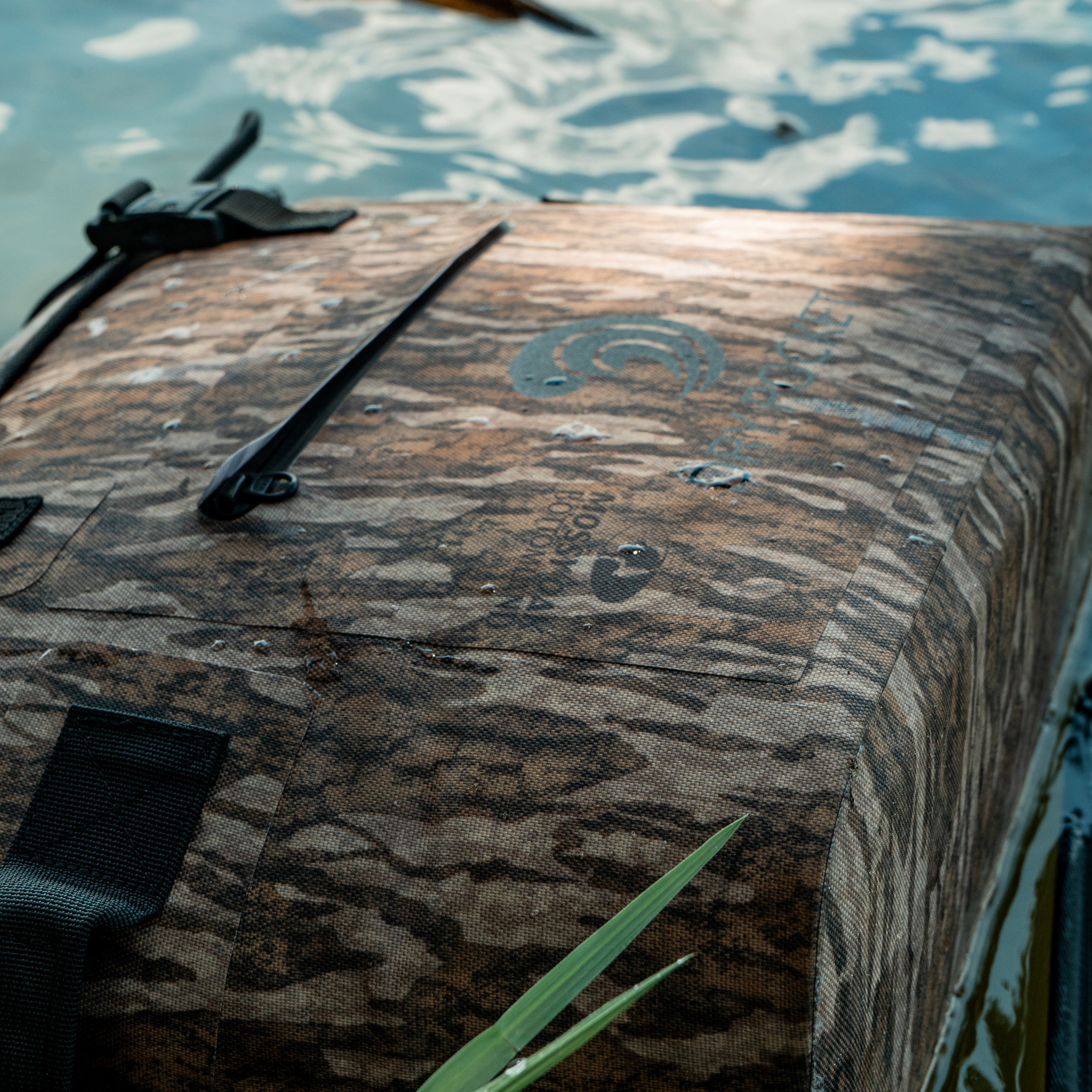 Bottomland Dry Pocket waterproof floating cooler bag with auto-sealing tote design, ideal for outdoor and water activities.