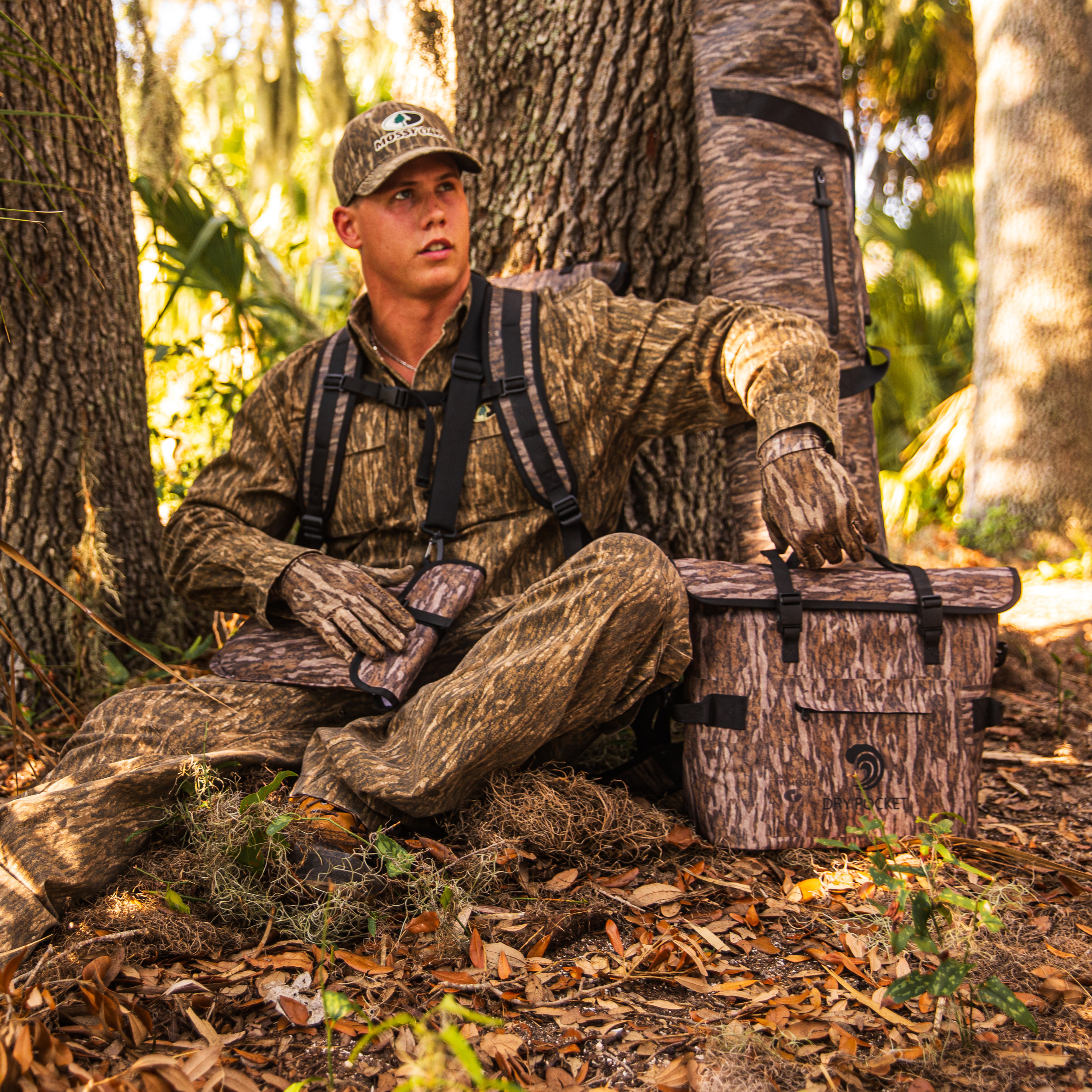 Bottomland Dry Pocket waterproof floating cooler bag with auto-sealing tote design, ideal for outdoor and water activities.