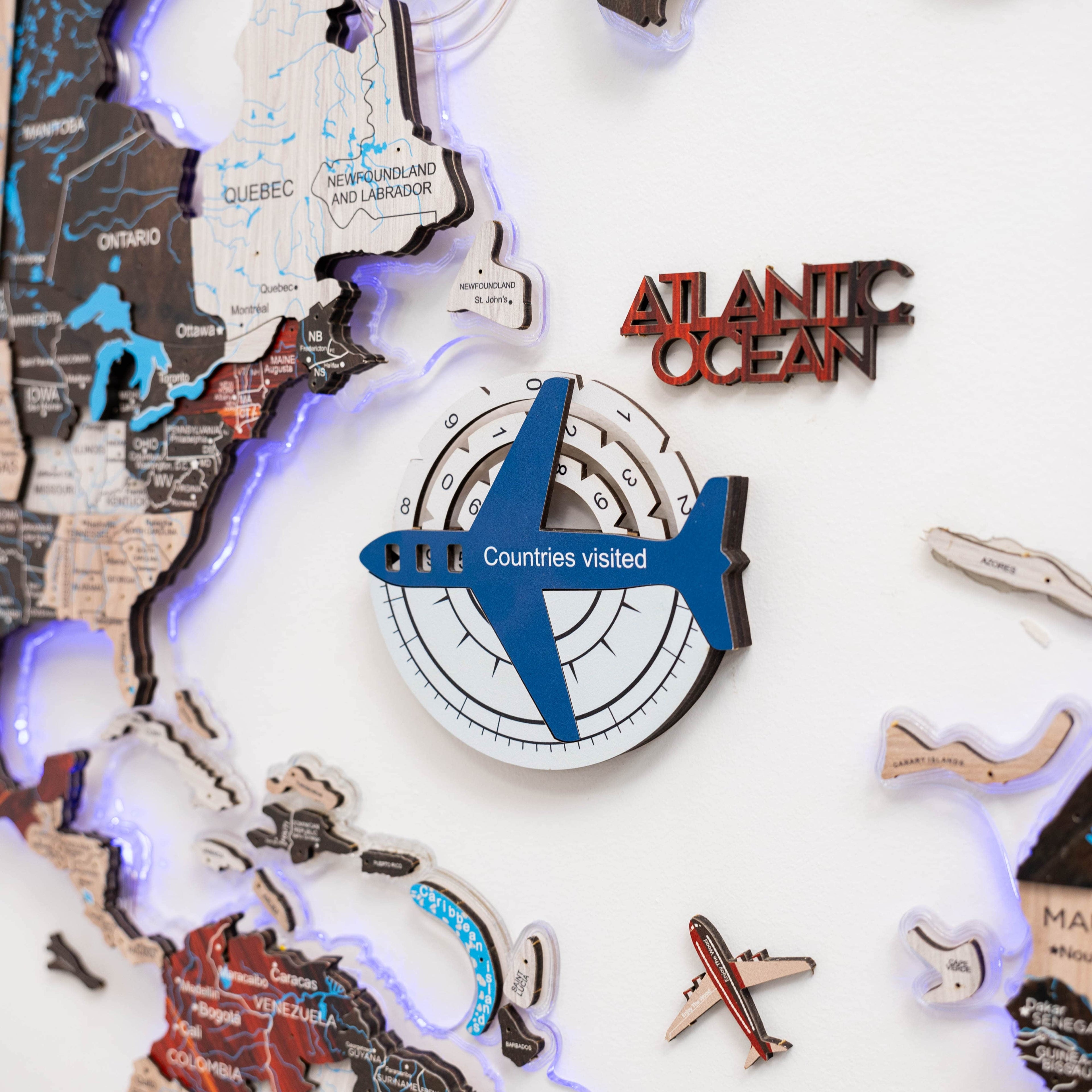 Enjoy The Wood Travel Tracker 3D colored wooden world map in aqua, featuring detailed continents and travel tracking markers.