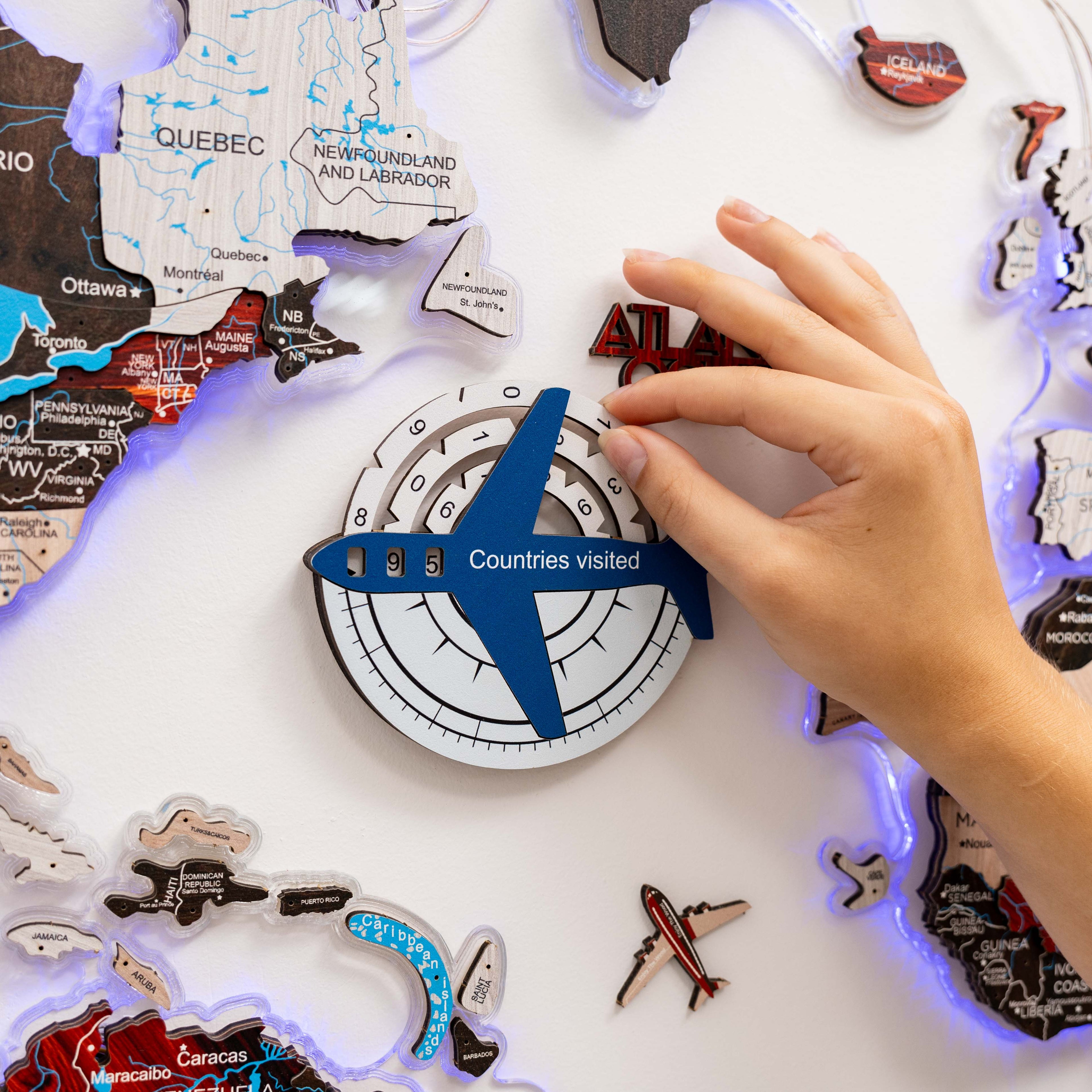 Enjoy The Wood Travel Tracker 3D colored wooden world map in aqua, featuring detailed continents and travel tracking markers.
