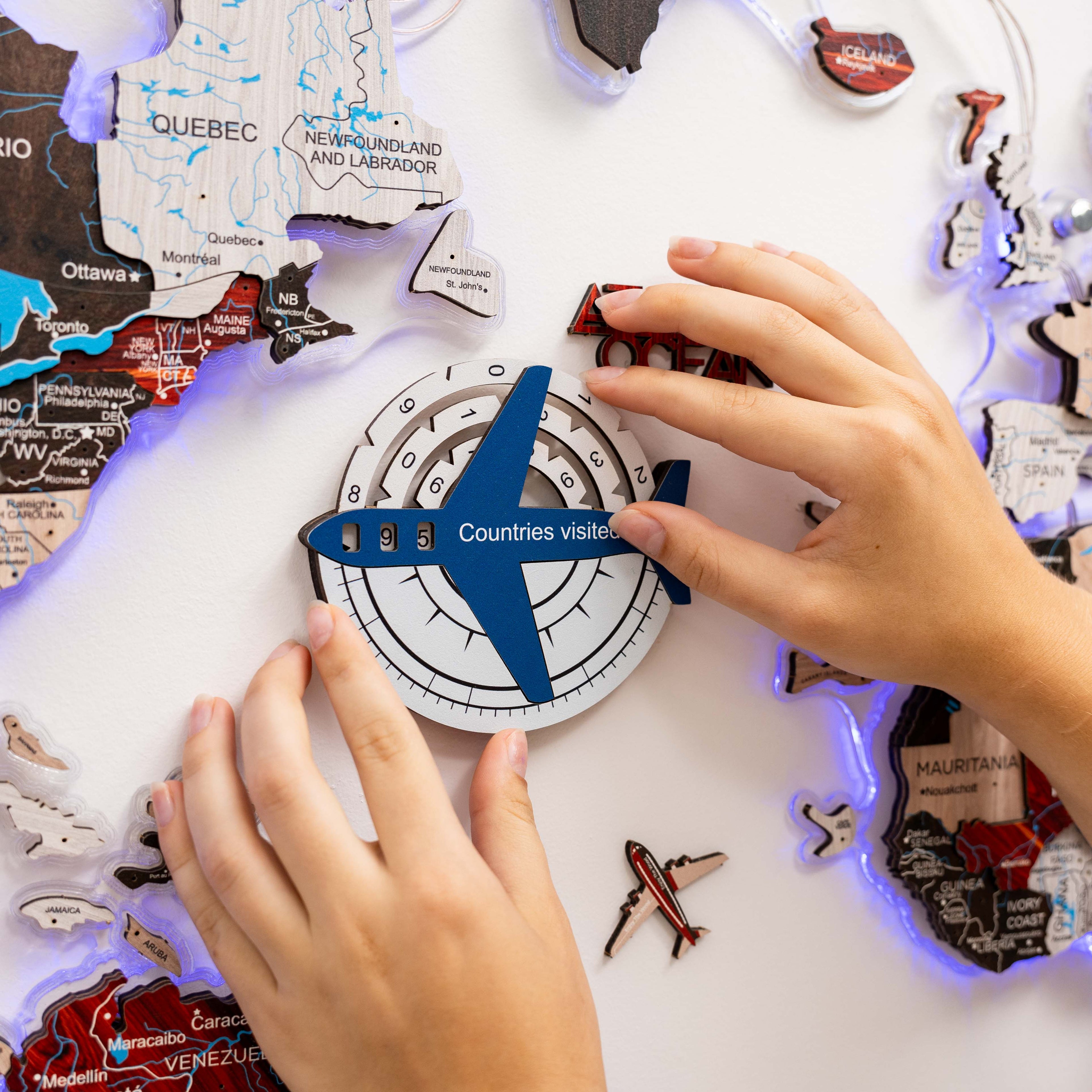 Enjoy The Wood Travel Tracker 3D colored wooden world map in aqua, featuring detailed wooden continents and travel marker accents.