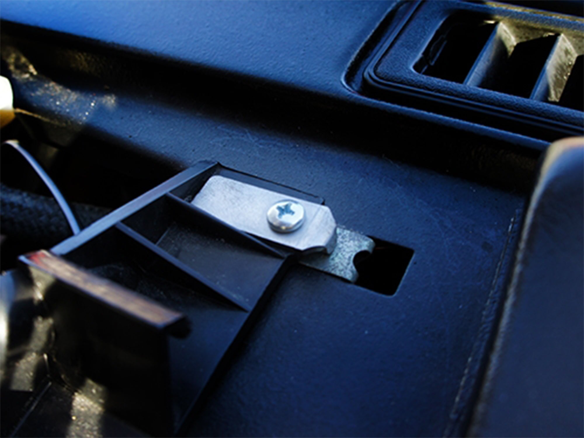 GoWesty instrument cluster mounting tab kit installed in a 1980-91 Vanagon, showing the secure metal brackets.