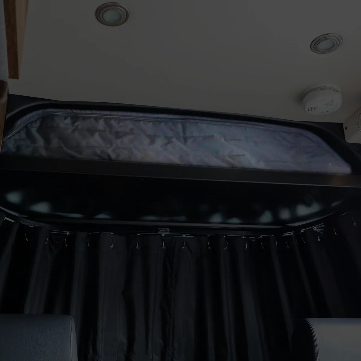 Canyon Adventure Vans CLIMA-SHADE™ insulated cab shelf cover in a vehicle interior, providing shade and insulation.