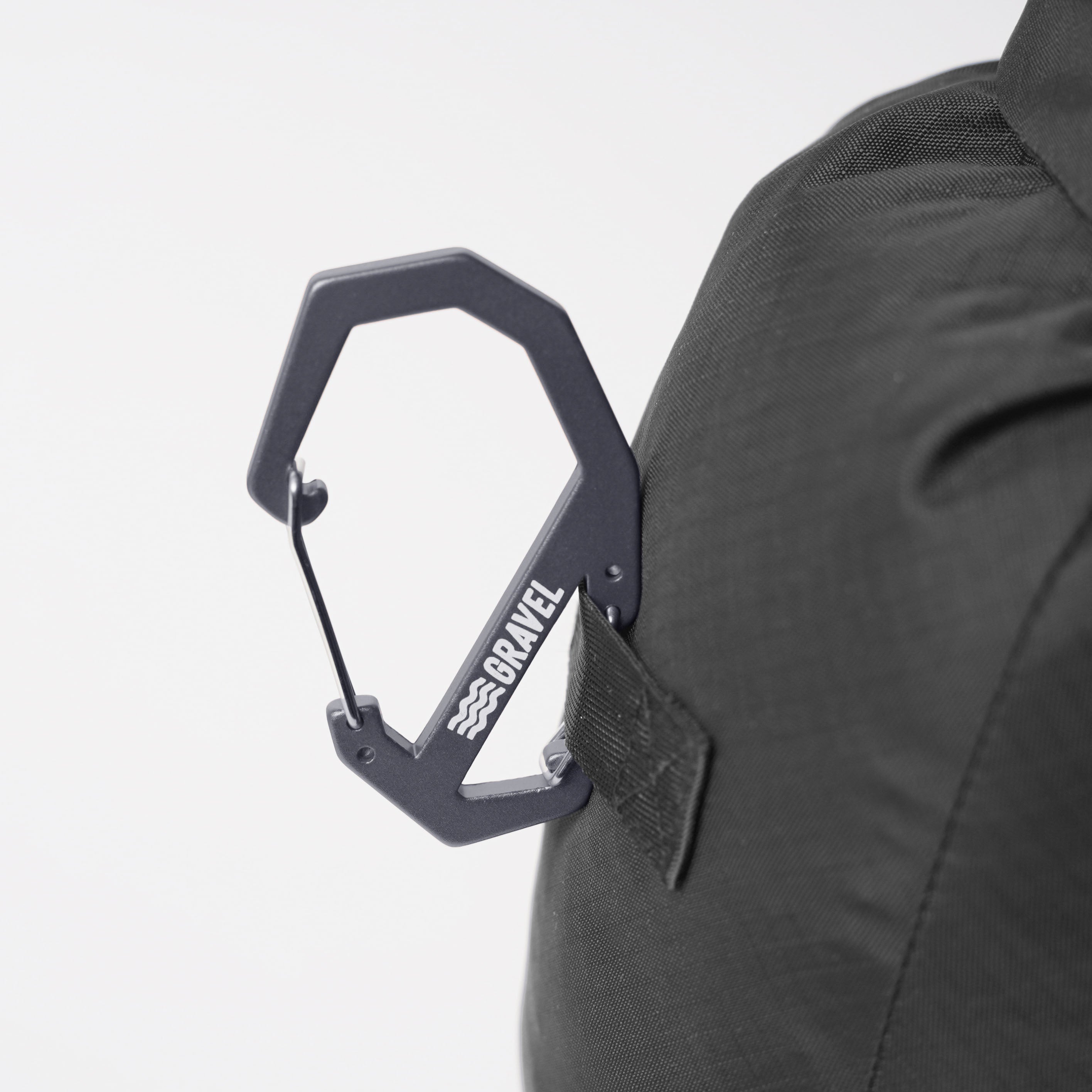 Gray Gravel carabiner displayed against a neutral background, highlighting its sturdy design and functional features.