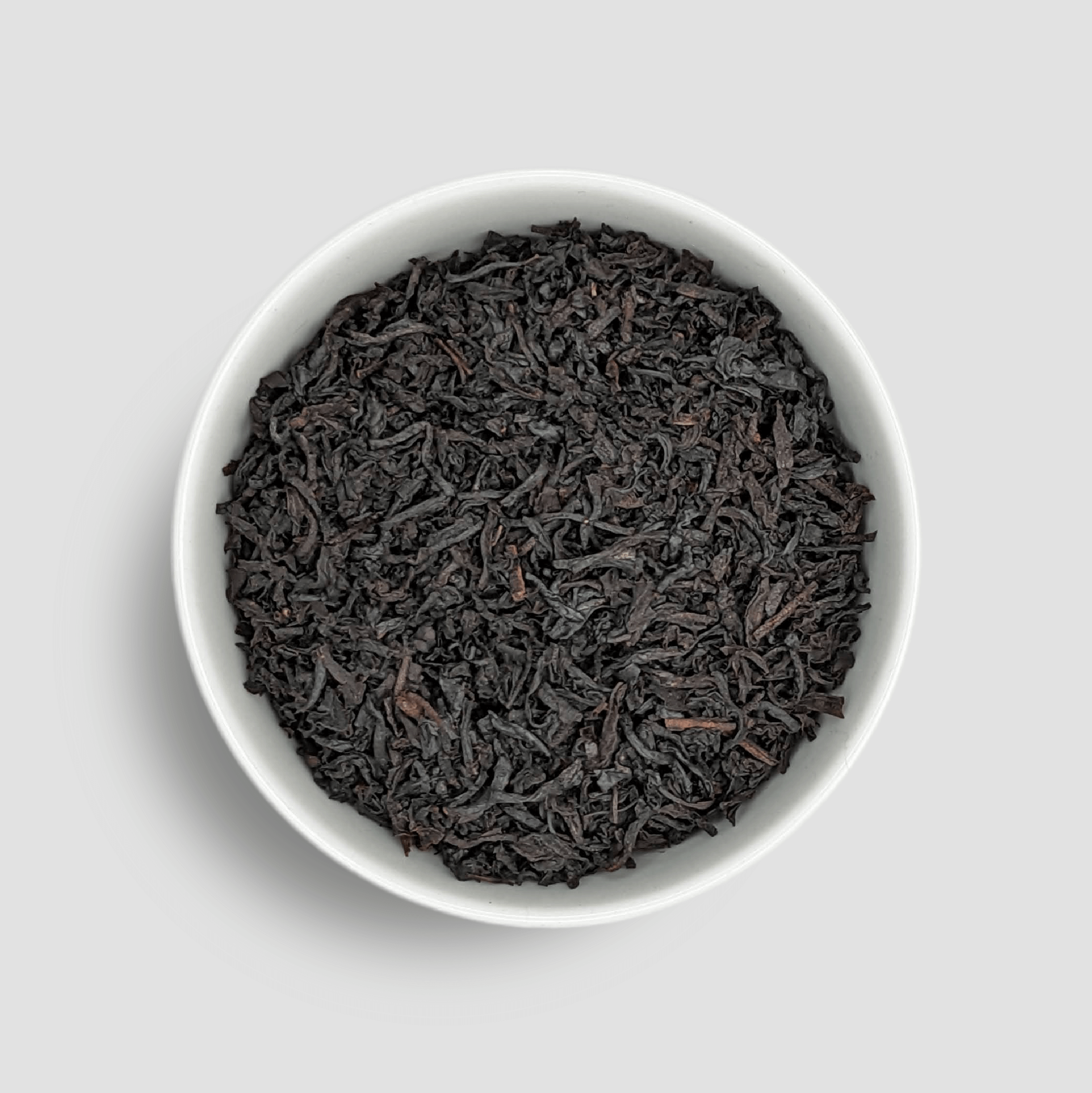Ceylon Vanilla black tea leaves in a bowl, highlighting the fragrant, high-quality tea from Little Prayer Tea Company.
