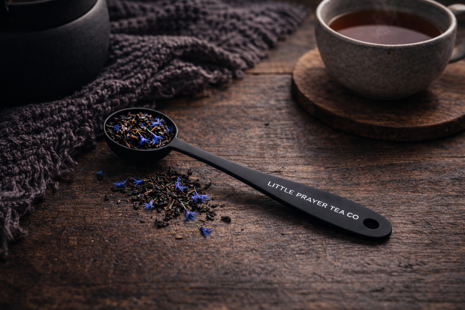 Little Prayer Tea Spoon with intricate design, perfect for stirring tea, displayed on a wooden surface.