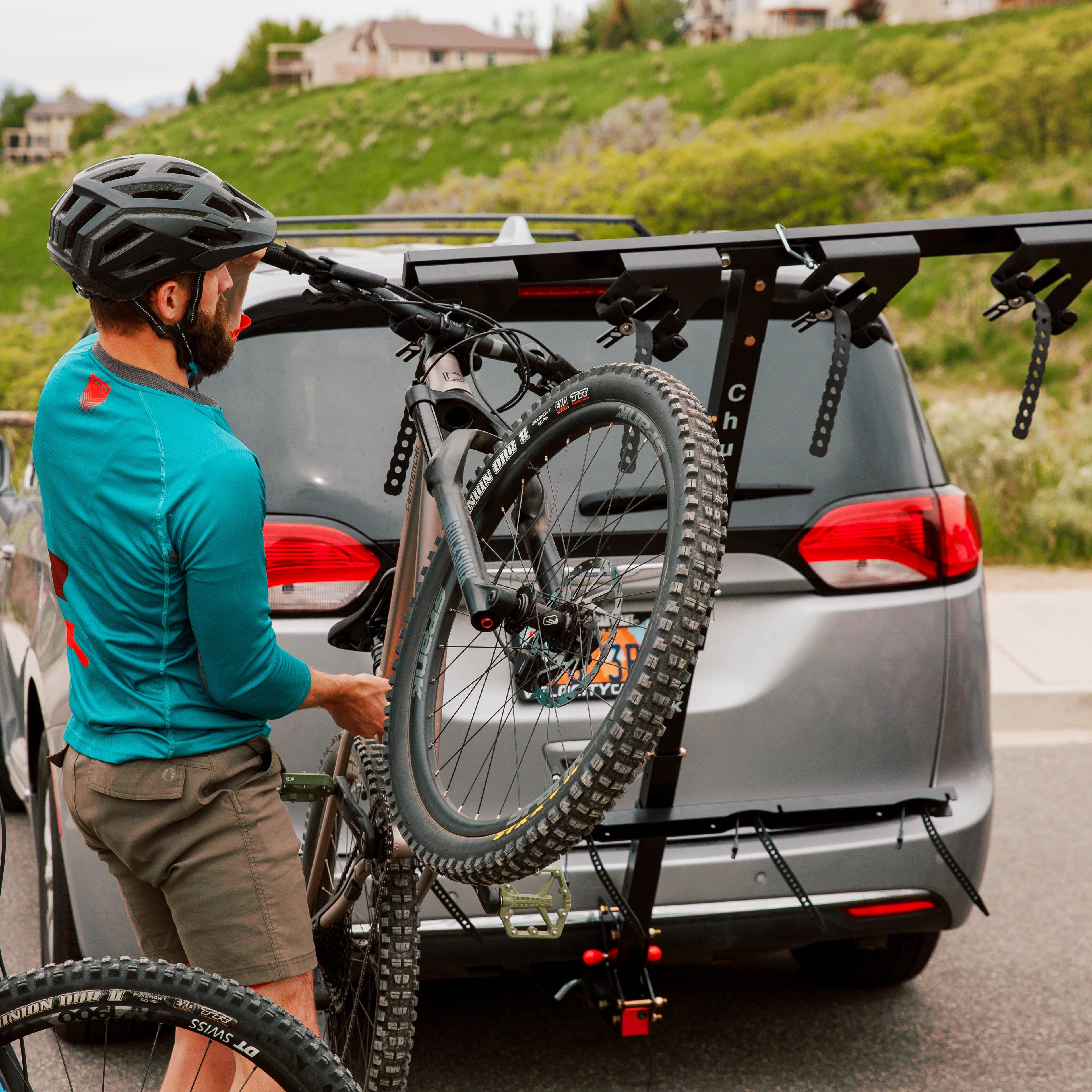 Vertical bike rack by Chuck for four bikes, featuring sturdy metal construction and secure hanging slots for easy storage.