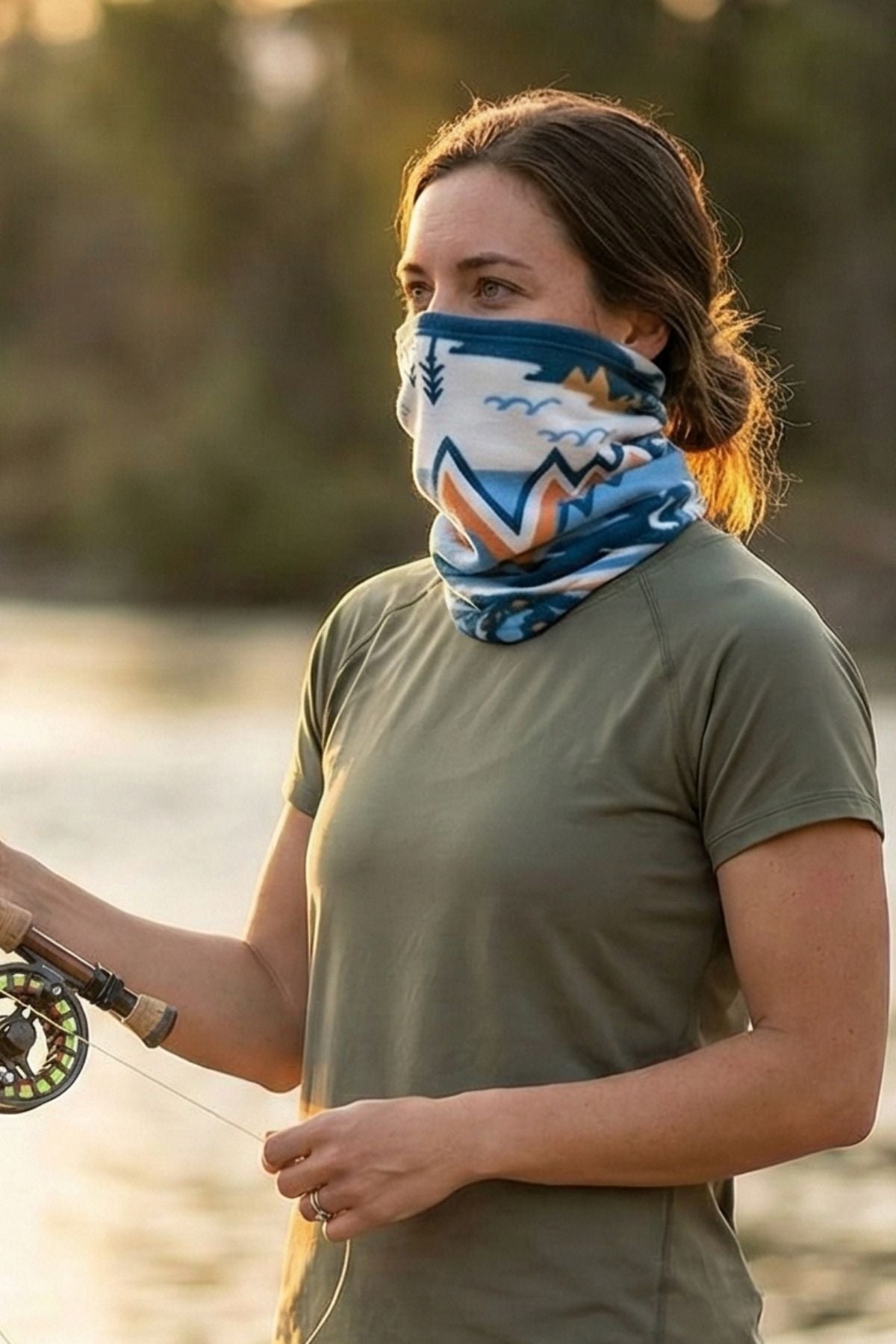 FisheWear Chummy reversible neck tube in bright blue and pink, worn as a versatile neck warmer or face covering.