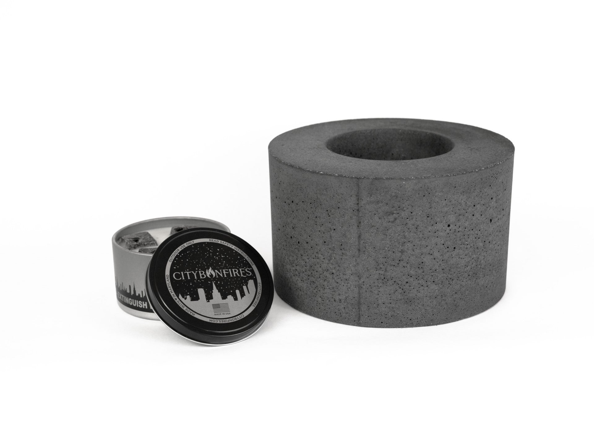 Classic Cylinder Concrete Fire Pit by City Bonfires with a smooth finish, showcasing flames and cozy outdoor ambiance.