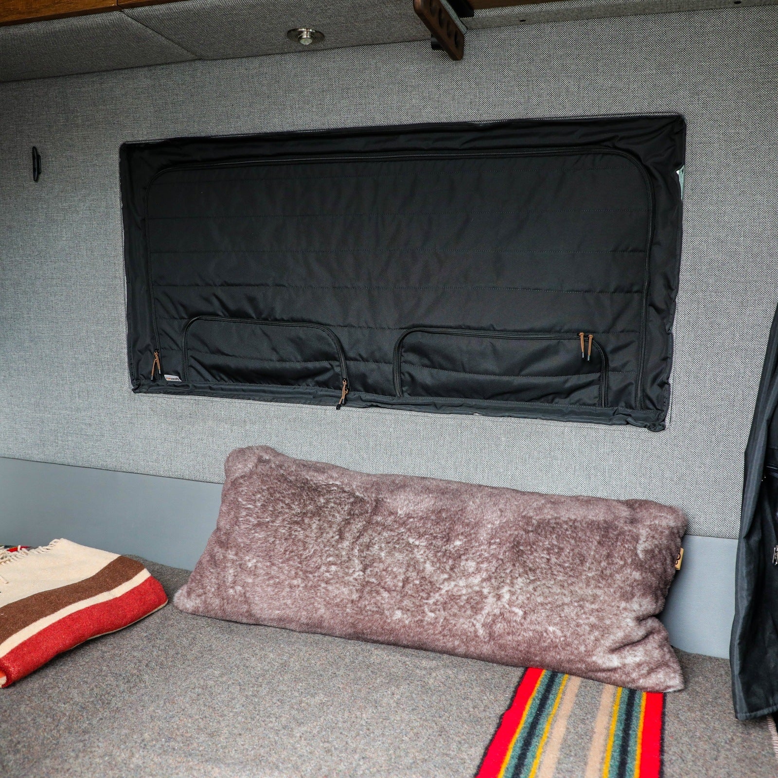 Canyon Adventure Vans CLIMA-SHADE insulated groove lounge window cover installed on a van window, providing thermal insulation and privacy.