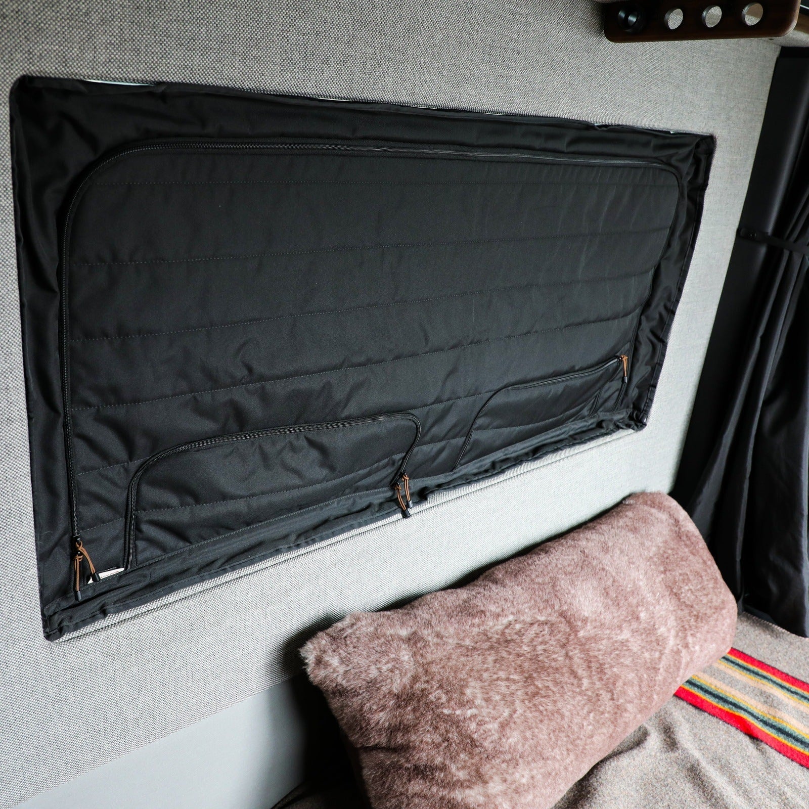 Canyon Adventure Vans CLIMA-SHADE insulated groove lounge window cover installed on a van window, providing shade and insulation.