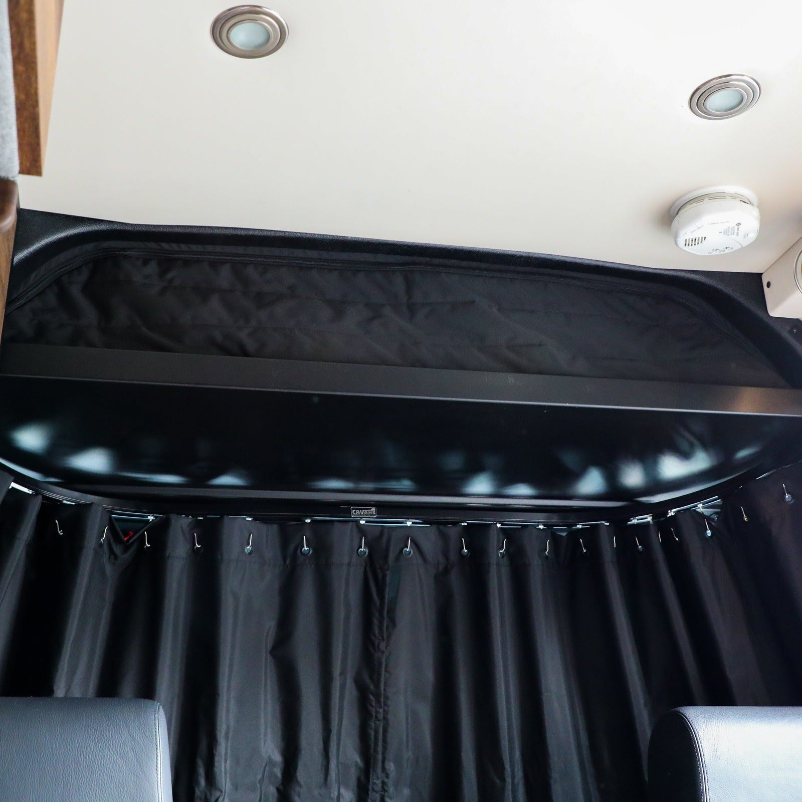 CLIMA-SHADE™ insulated cab shelf cover by Canyon Adventure Vans, featuring durable fabric and a sleek design for vehicle interiors.