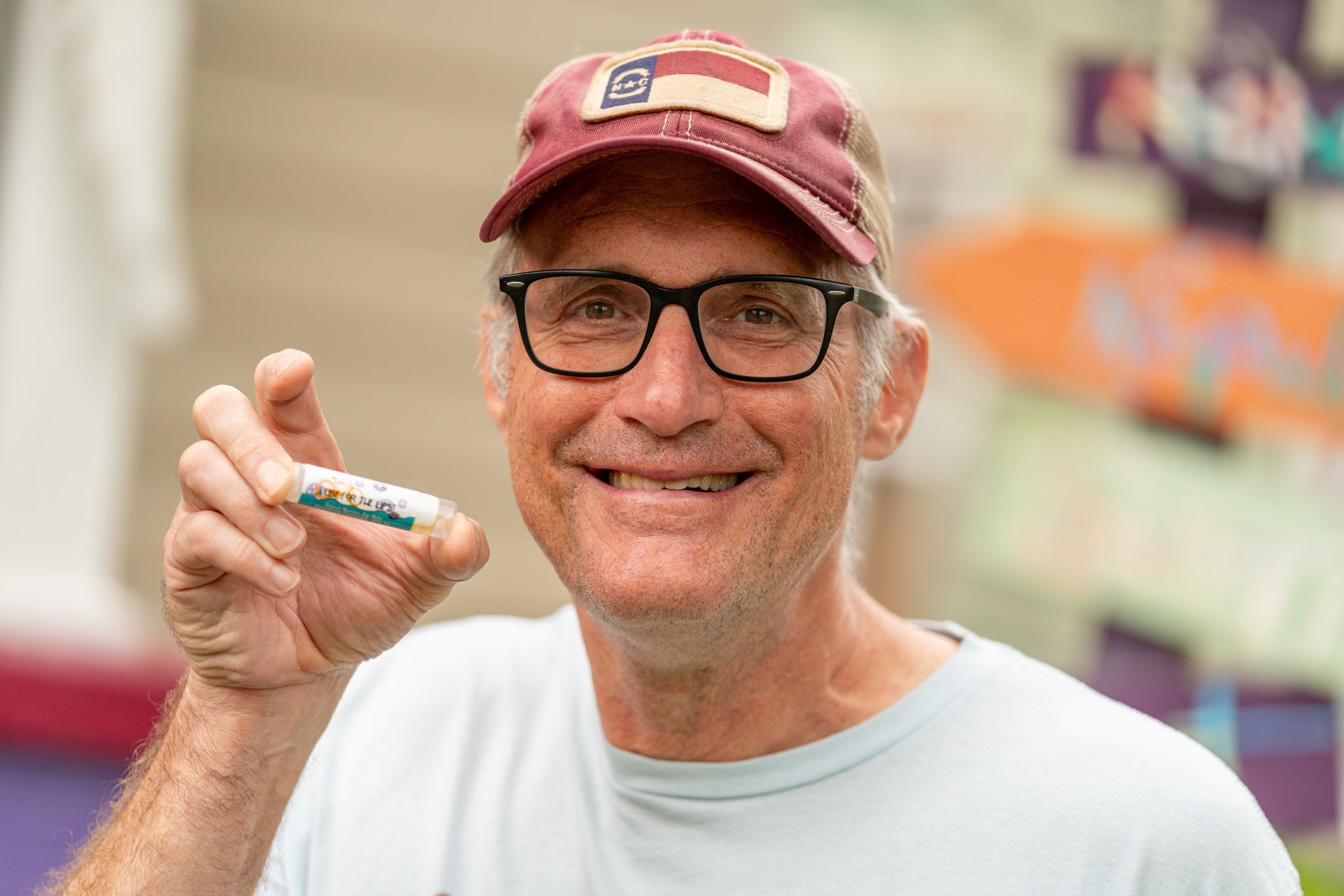 Essential Journeys Coasting Coconut SPF 15 Lube for the Lips™ in a tube, featuring coconut flavor and moisturizing texture.