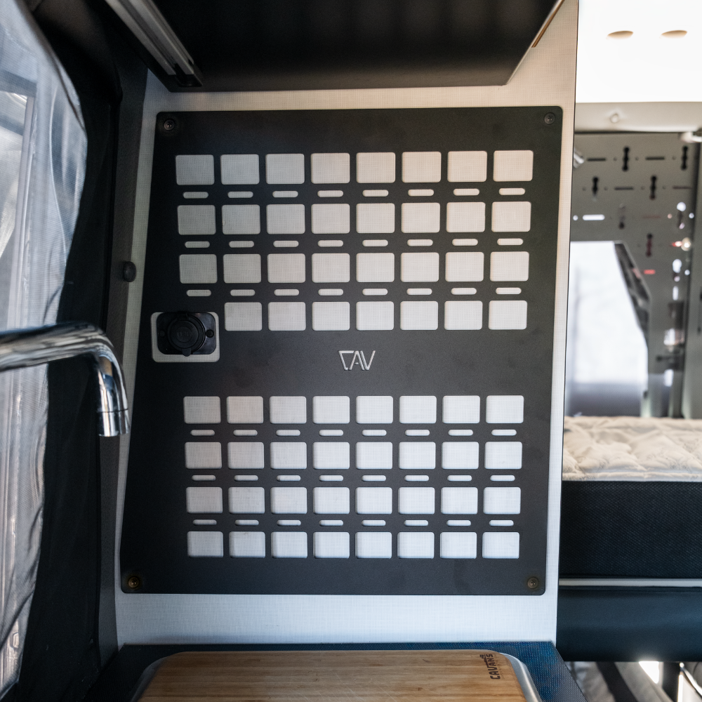 Revel Kitchen MOLLE Panel by Canyon Adventure Vans mounted on a wall, made in Utah, featuring multiple attachment points for gear organization.