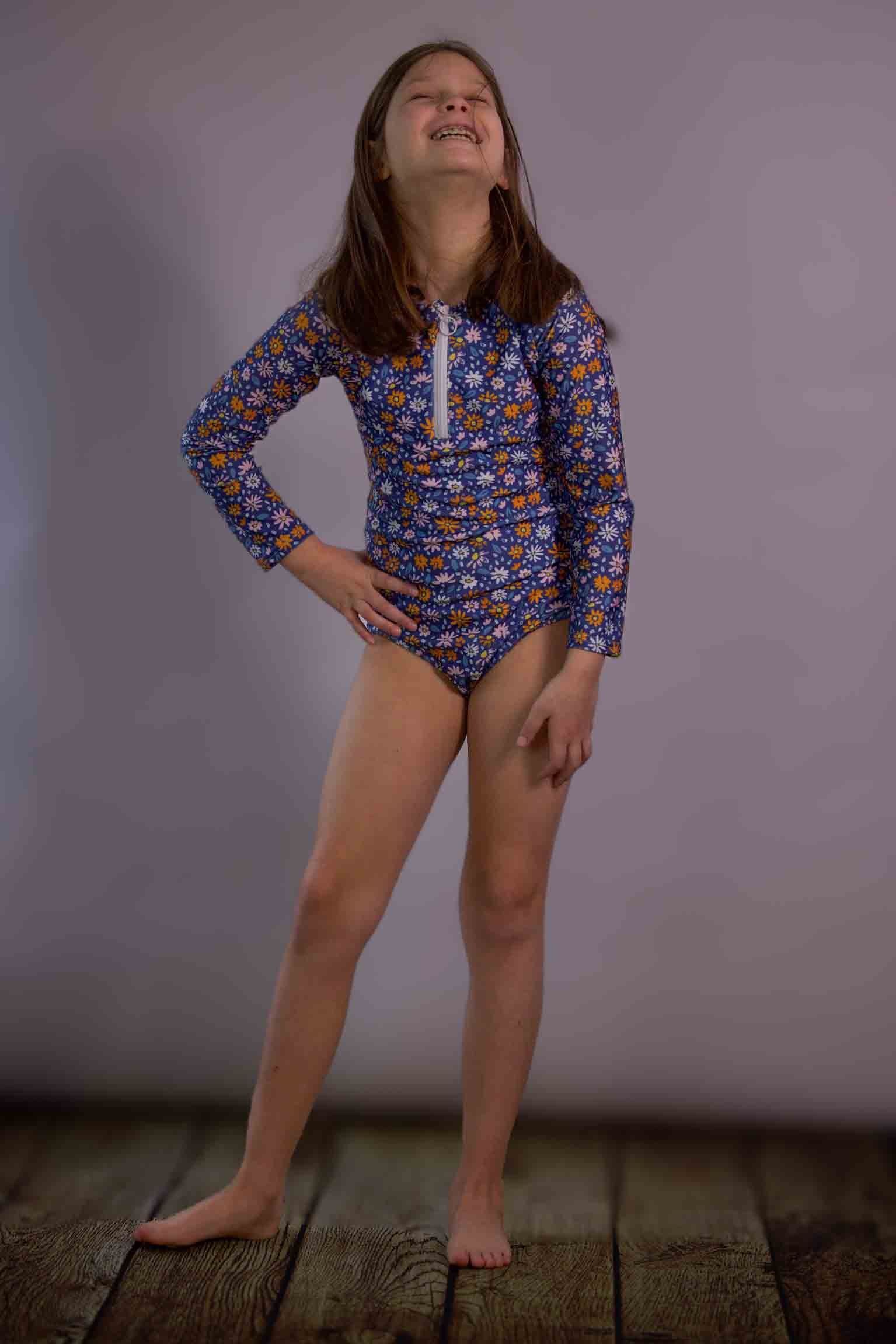 Keep the Littles Wild flowers swimsuit featuring a colorful floral pattern on a stylish one-piece for girls' swimwear.