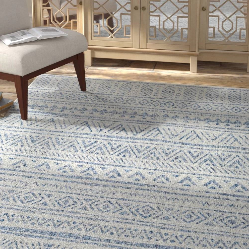 Blue grey chevron coastal boho style indoor outdoor area rug by HomePacific, shown in a cozy living space.