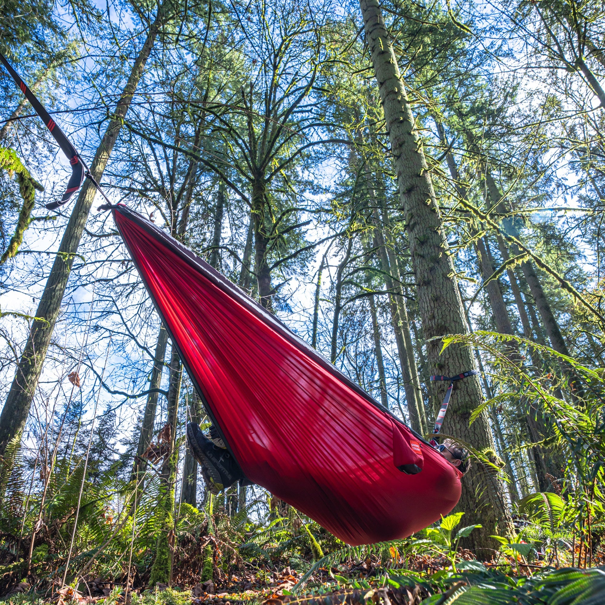 GrandTrunk Double Deluxe Hammock with straps, showcasing its soft fabric, sturdy build, and attached suspension straps for outdoor relaxation.
