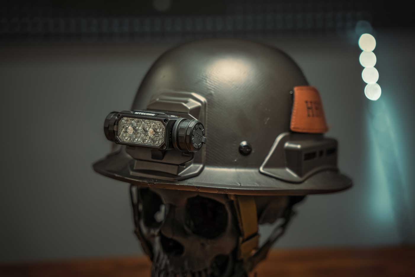 Hard Head Veterans NITECORE HC65M headlamp with adjustable strap and LED light for outdoor activities and hands-free illumination.
