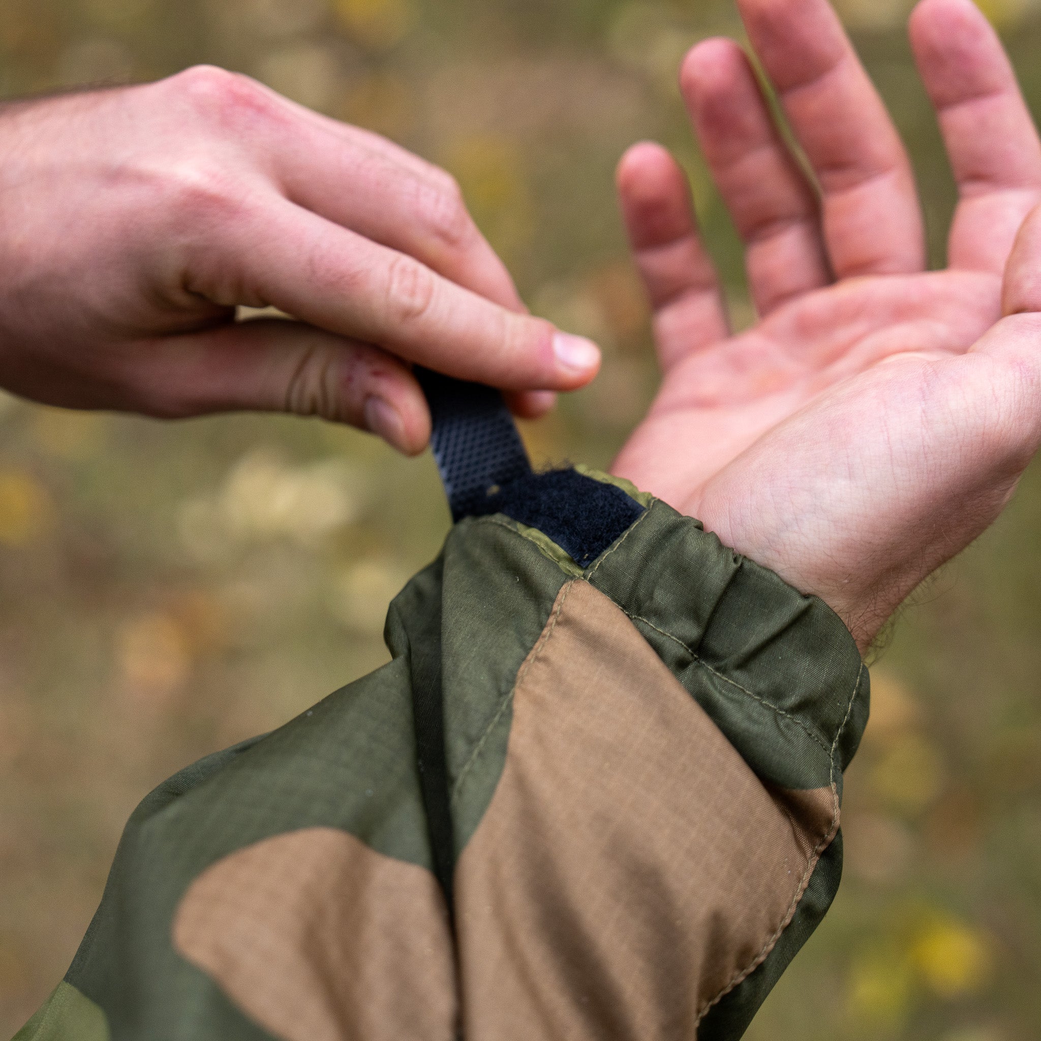 QILO x AP retro windbreaker in Norwegian Woodland camouflage by Americana Pipedream Apparel, shown in outdoor setting.