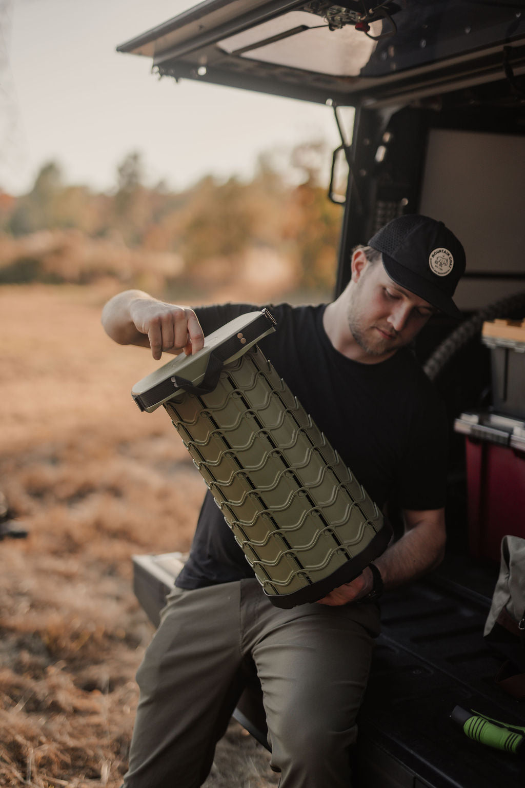 EverUncharted Nomad Seat portable camping chair in moss green, lightweight camping furniture for outdoor adventures.