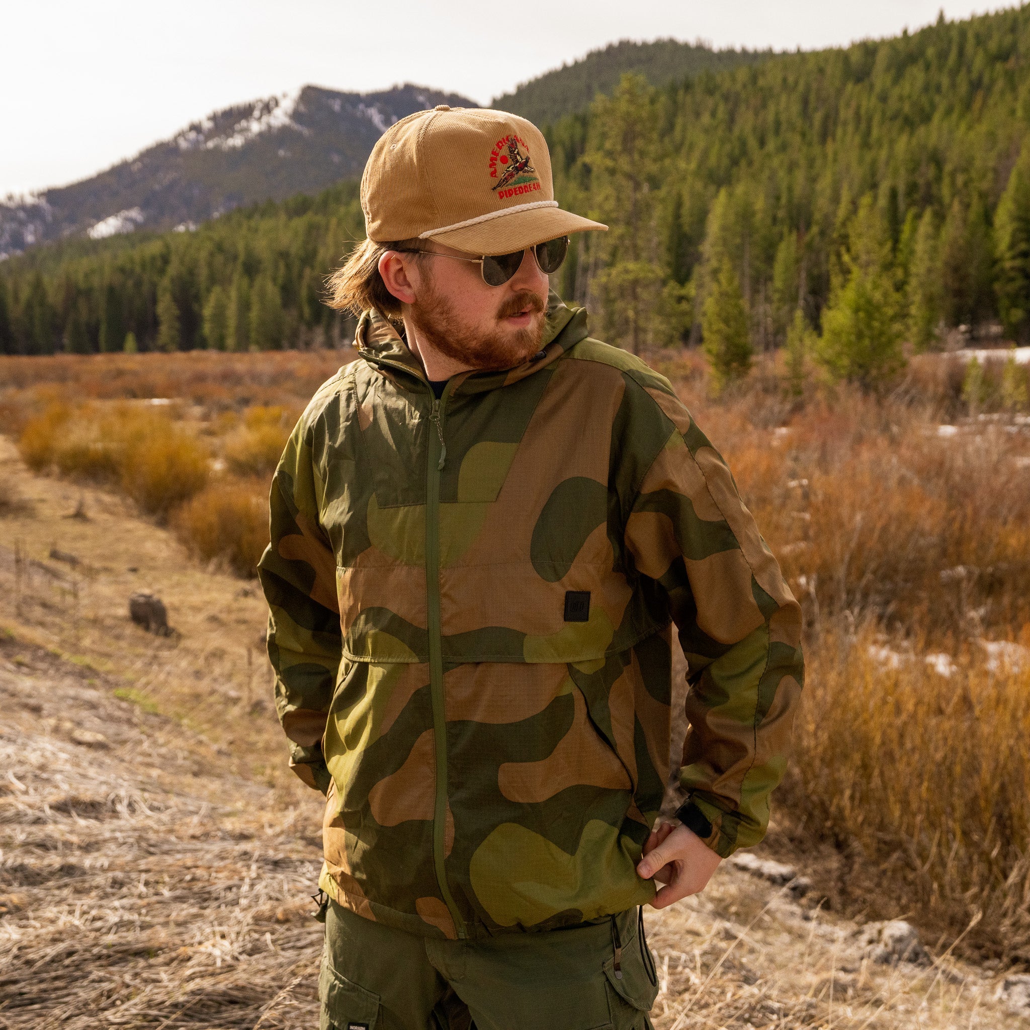 QILO x AP Retro Windbreaker in Norwegian Woodland pattern by Americana Pipedream Apparel, shown in front view with detailed fabric design.