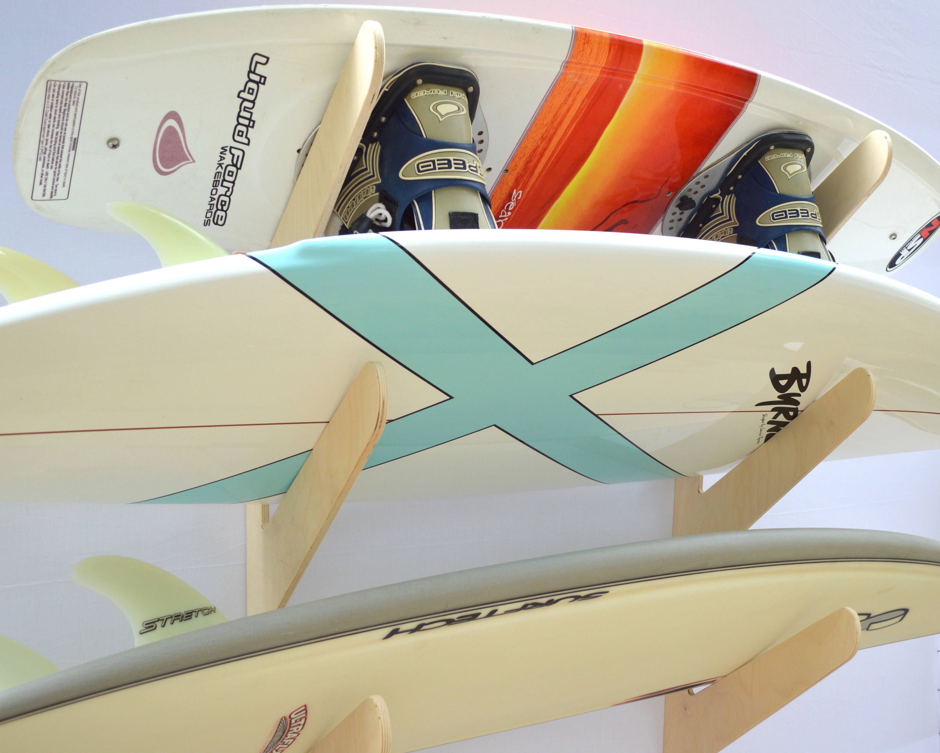 Rado Racks The Exhibitor surfboard wall rack mounted on a wall, showcasing its sturdy design for storing surfboards securely.