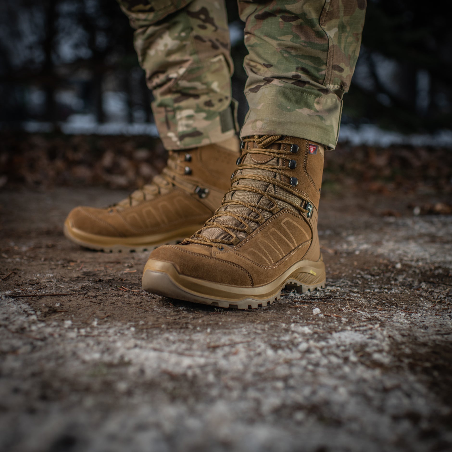 M-TAC tactical winter boots shown from the side with rugged rubber soles and insulated design for cold weather outdoor use.