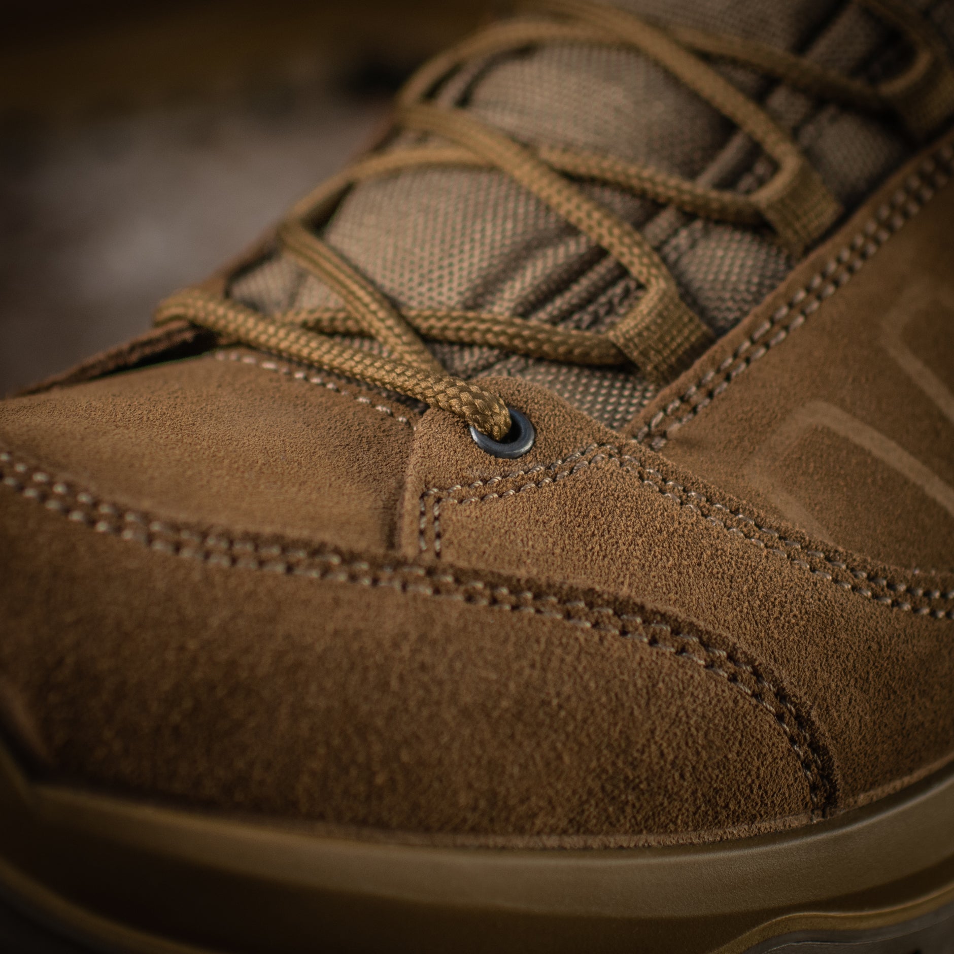 Close-up of black M-Tac tactical winter boots with rugged soles and waterproof material, designed for durability and cold weather use.