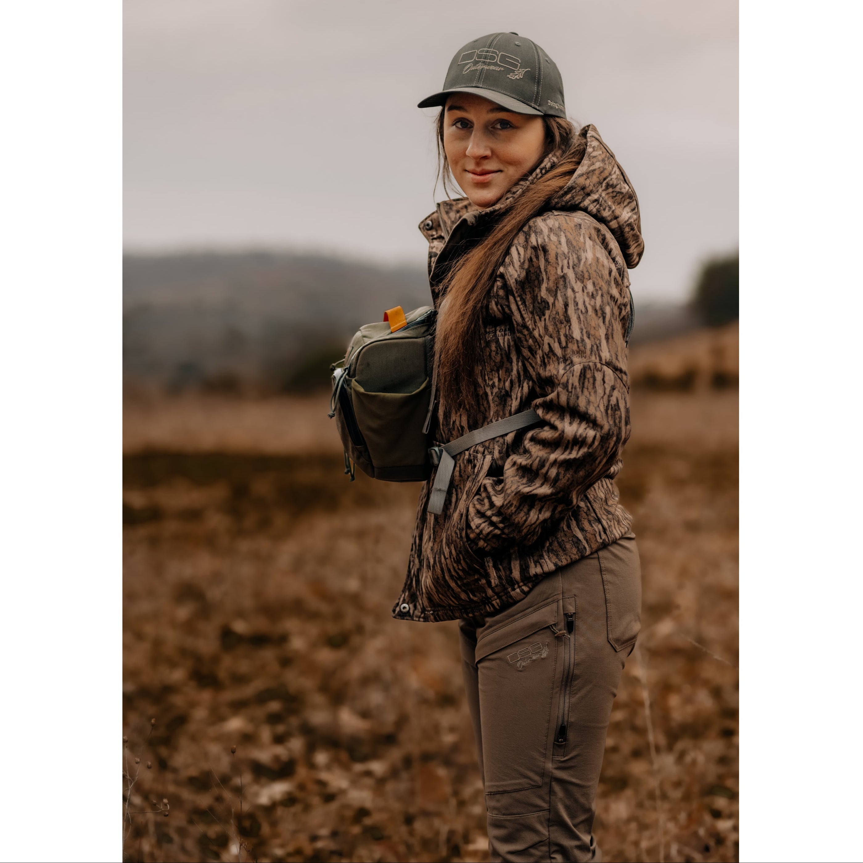 DSG OUTERWEAR Ava 3.0 jacket in dark color, featuring a sleek design with zippered pockets and a hood, suitable for outdoor wear.